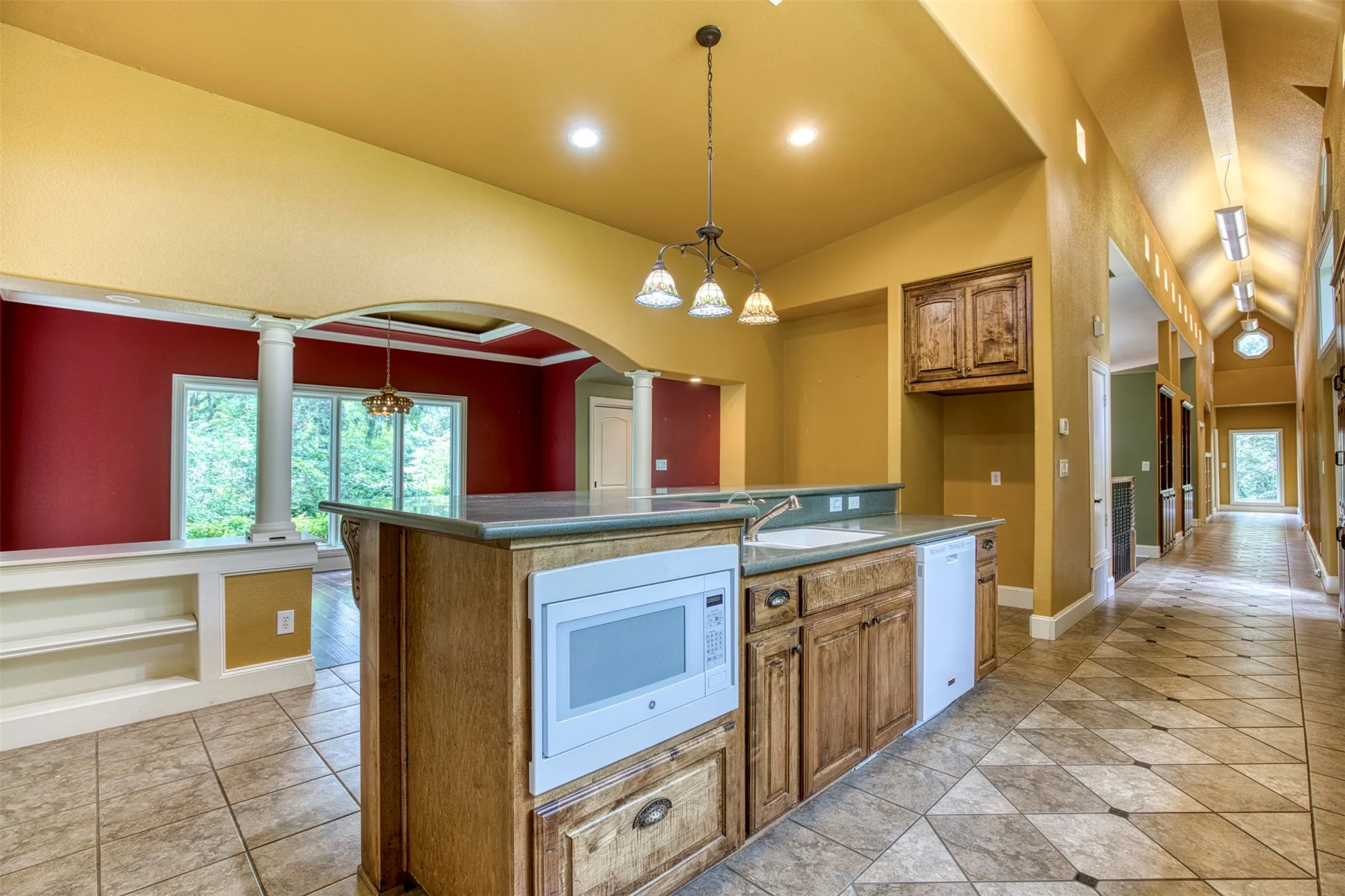 Kitchen features large eat-in island with storage.