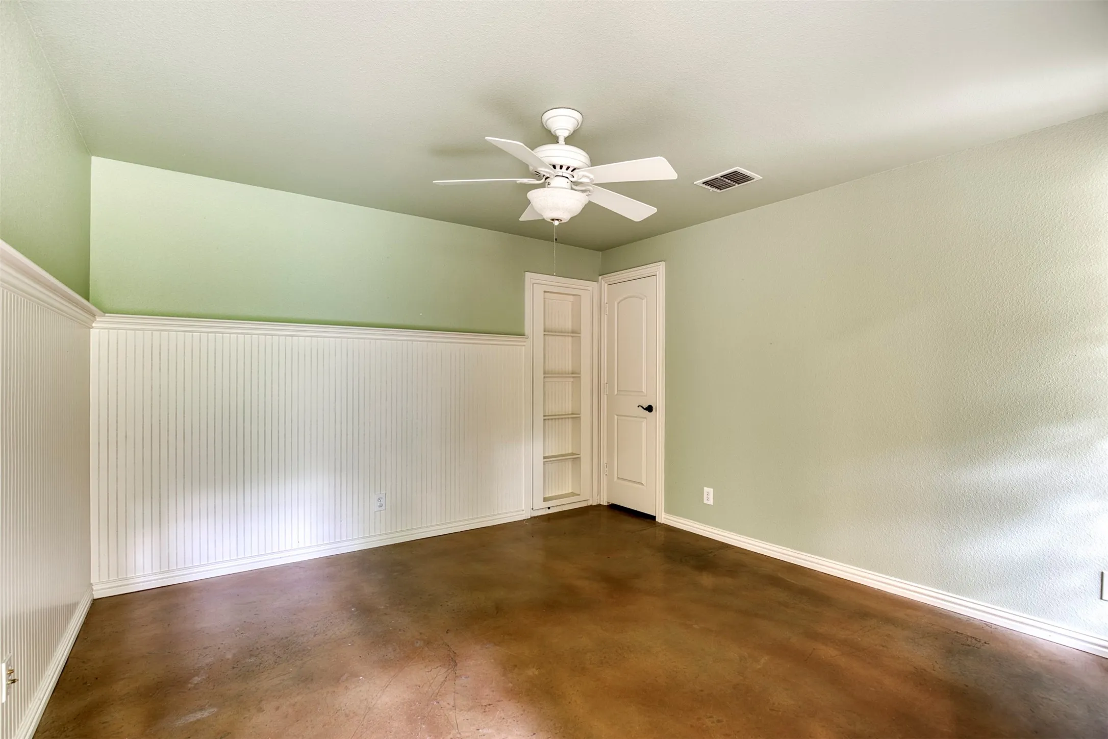 Downstairs bedroom with built-in and closet.