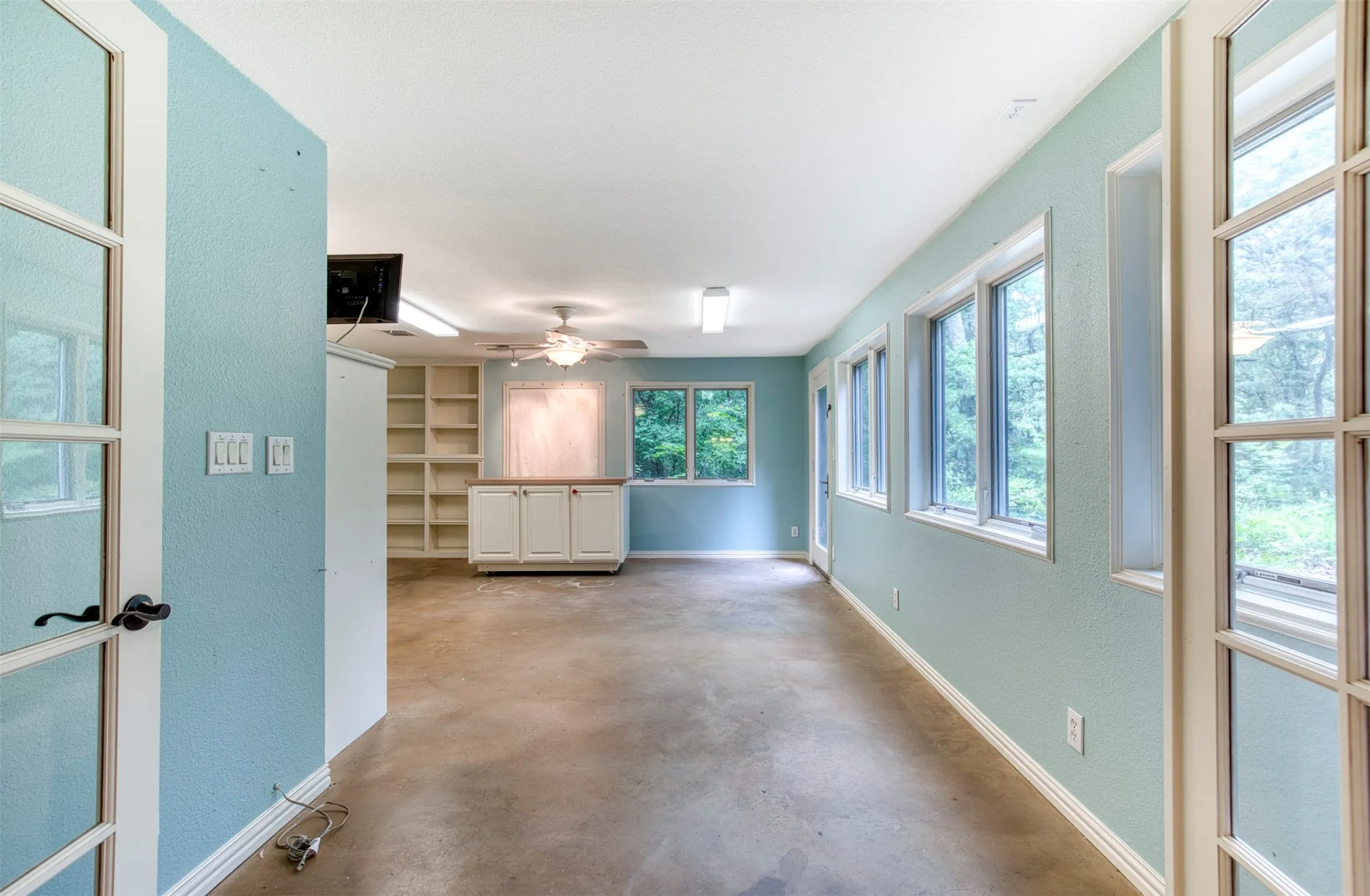 Downstairs bonus room with built-ins and windows throughout.