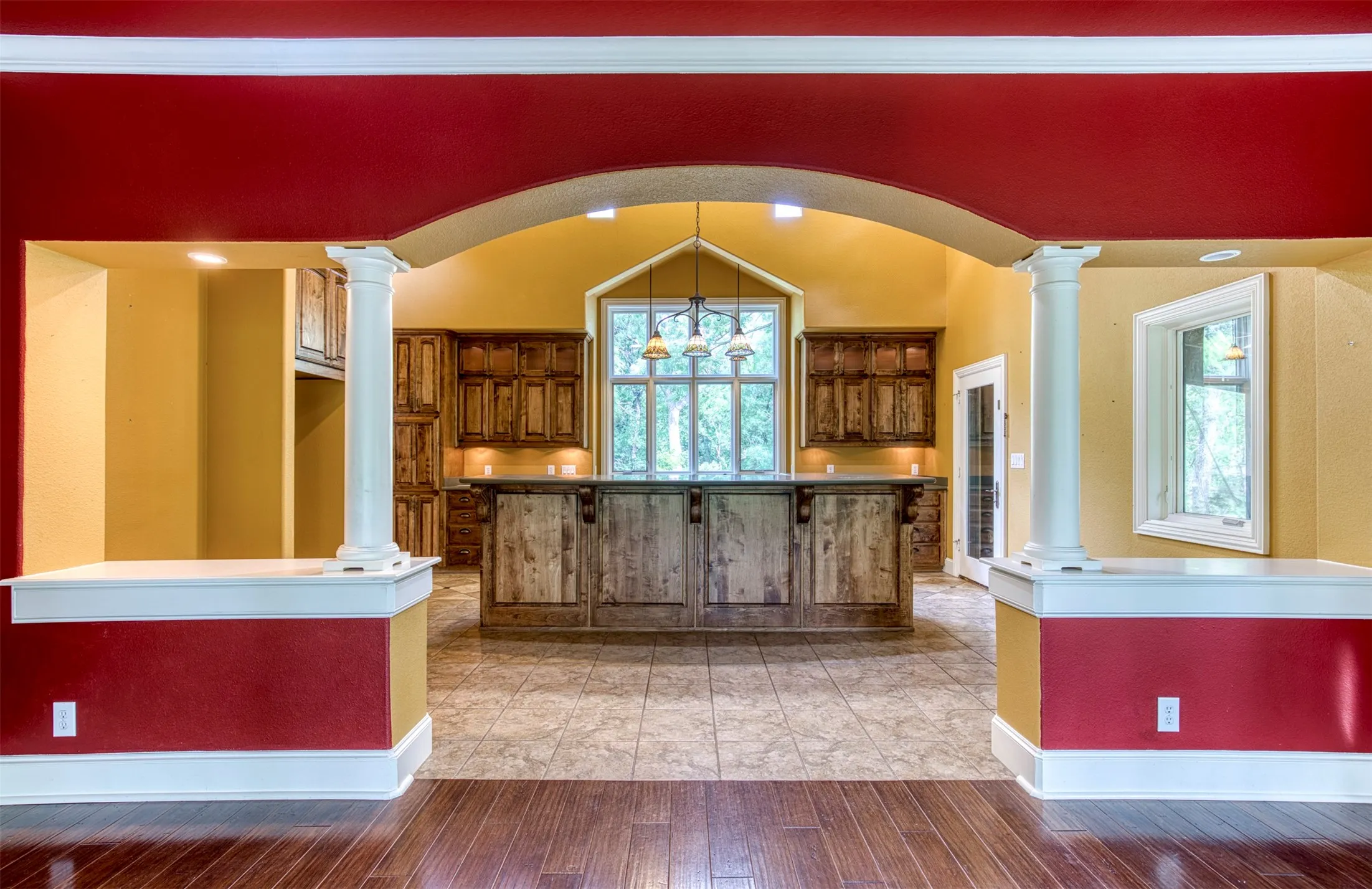 Kitchen showcasing grand entry with columns.