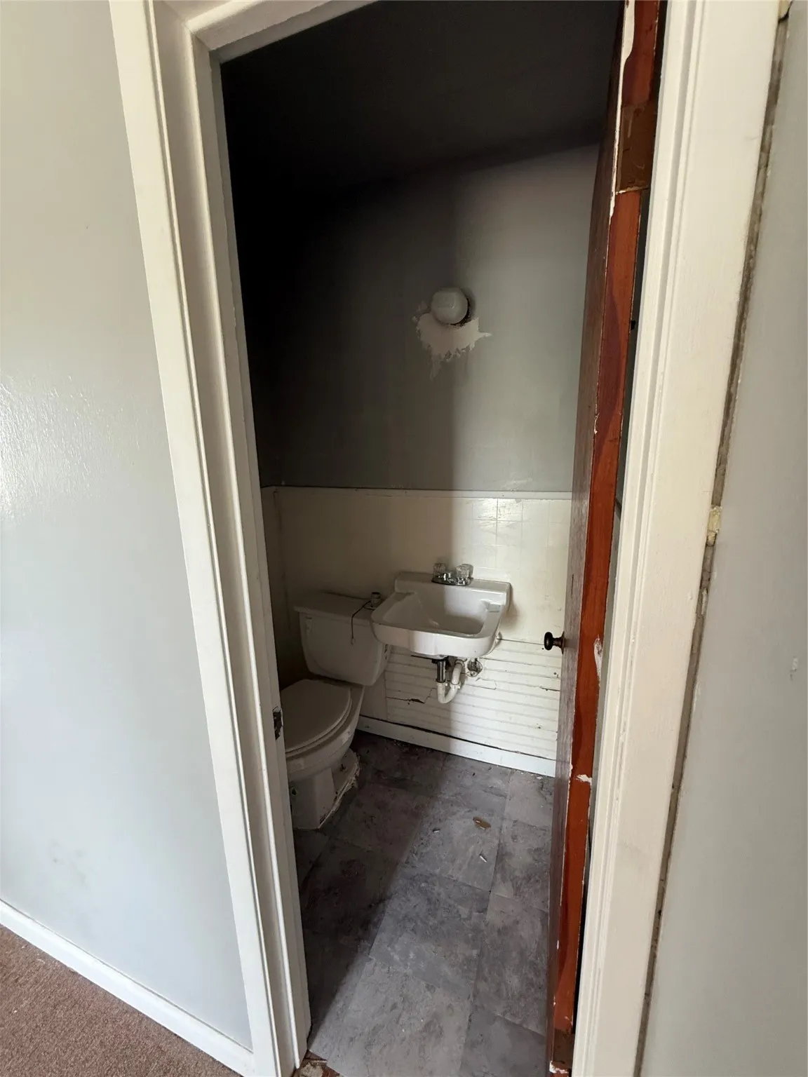 Half bath featuring a sink and toilet
