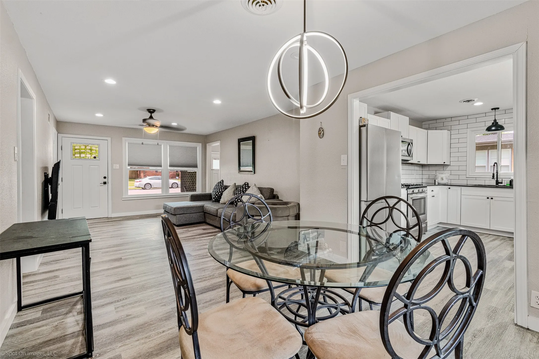 Dining space with light wood-type flooring, ceiling fan, recessed lighting, and baseboards