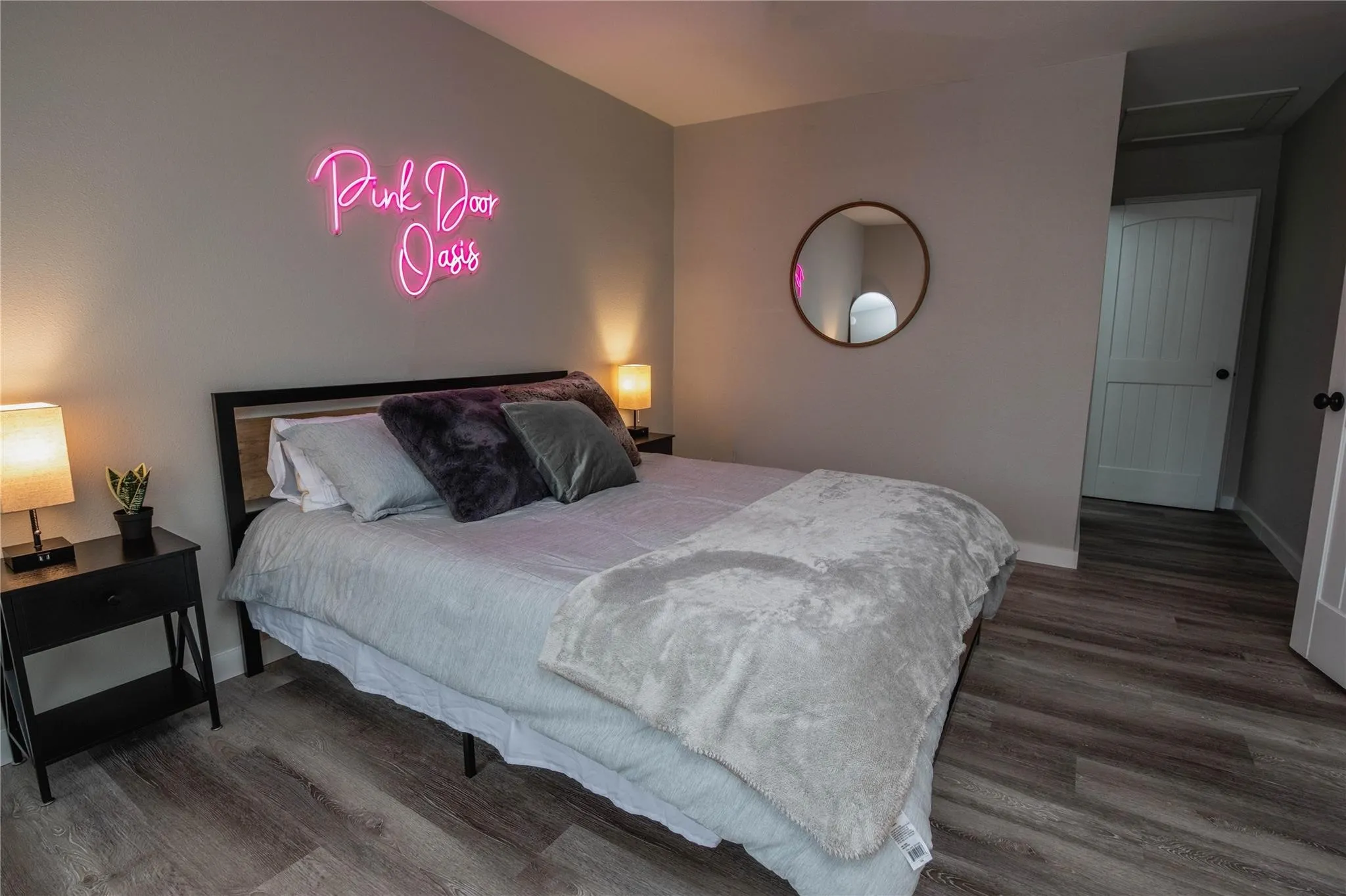 Bedroom with wood finished floors and baseboards