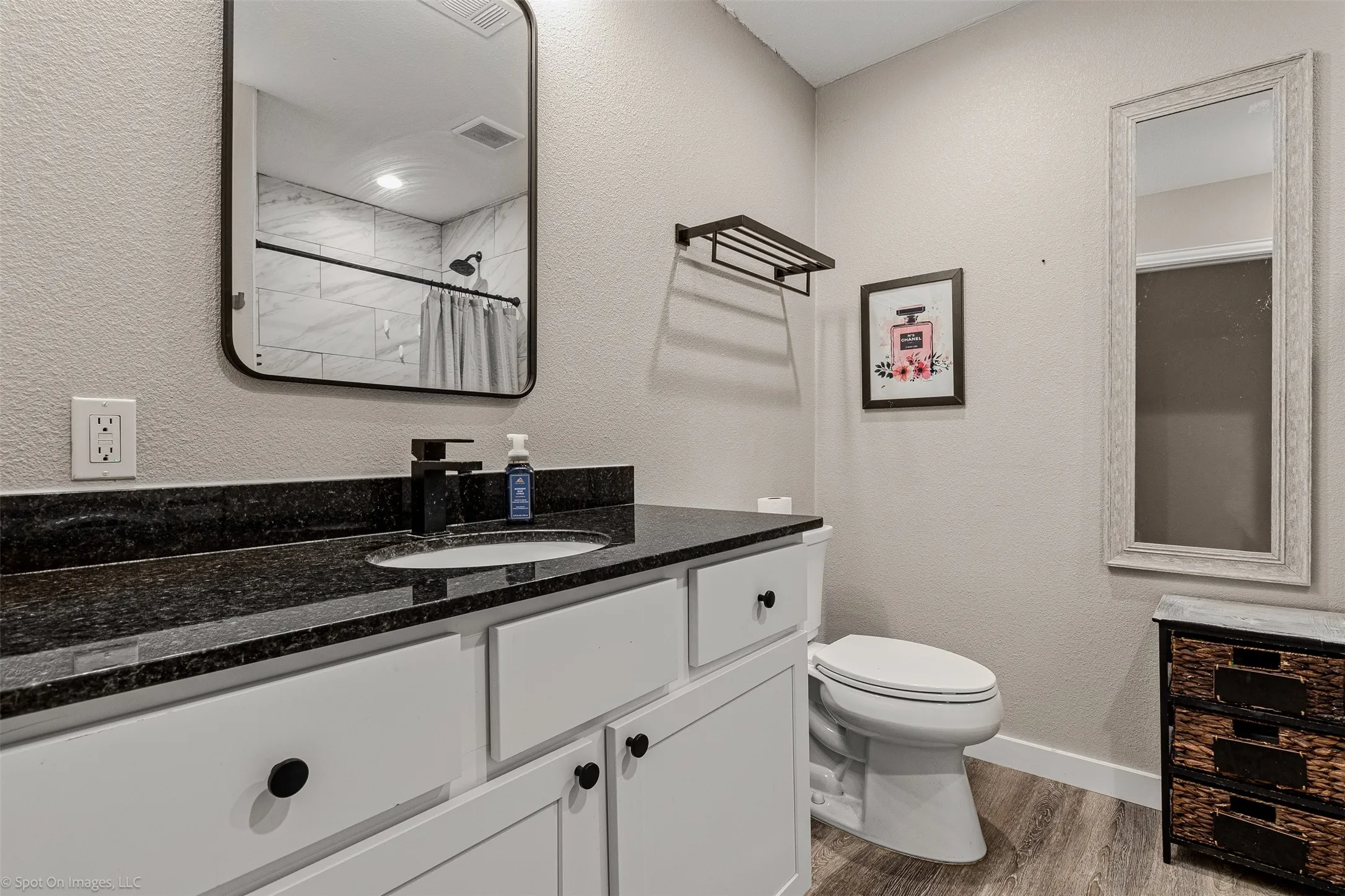 Full bath featuring wood finished floors, vanity, toilet, baseboards, and a shower with shower curtain