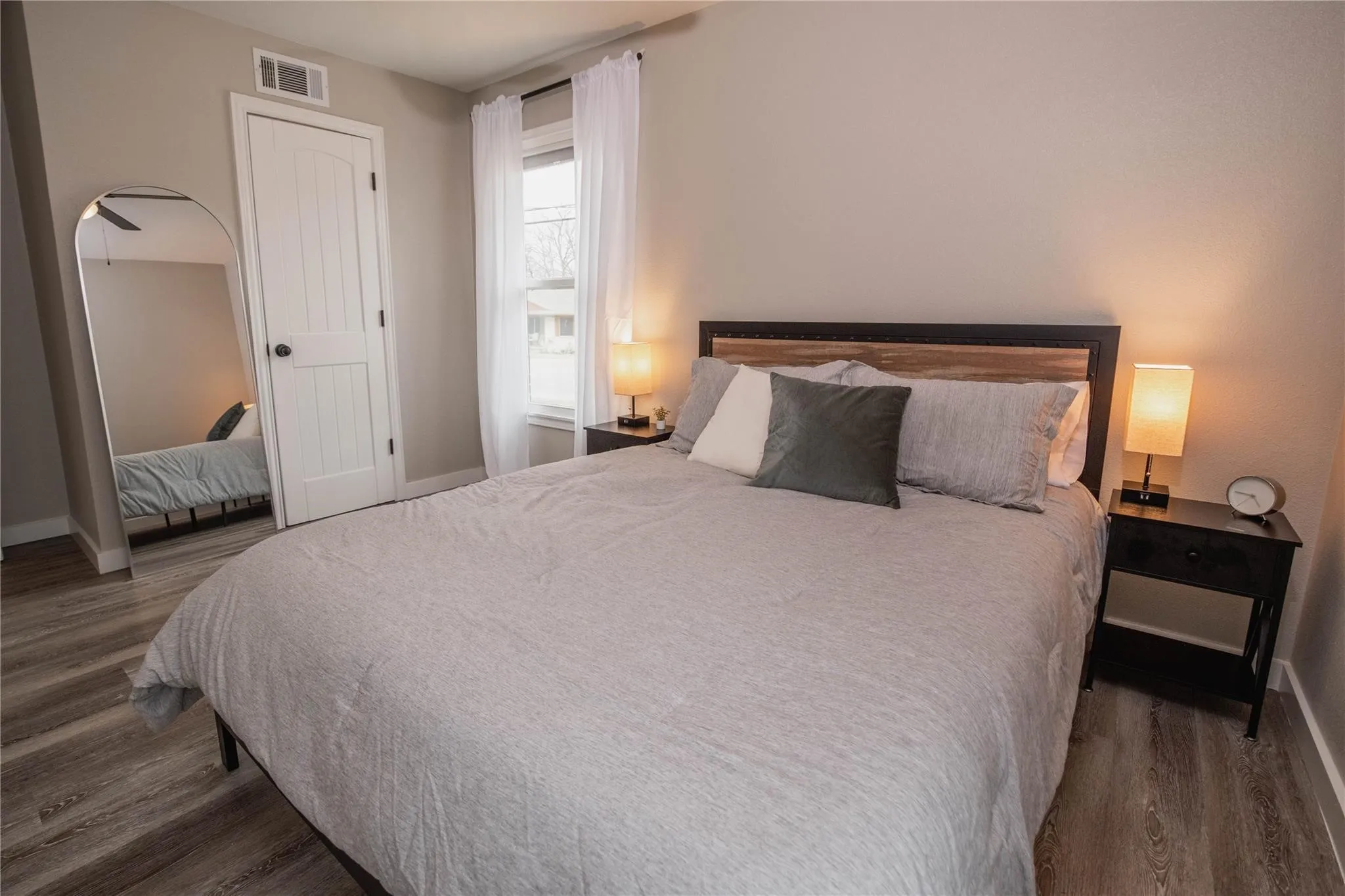 Bedroom with wood finished floors and baseboards