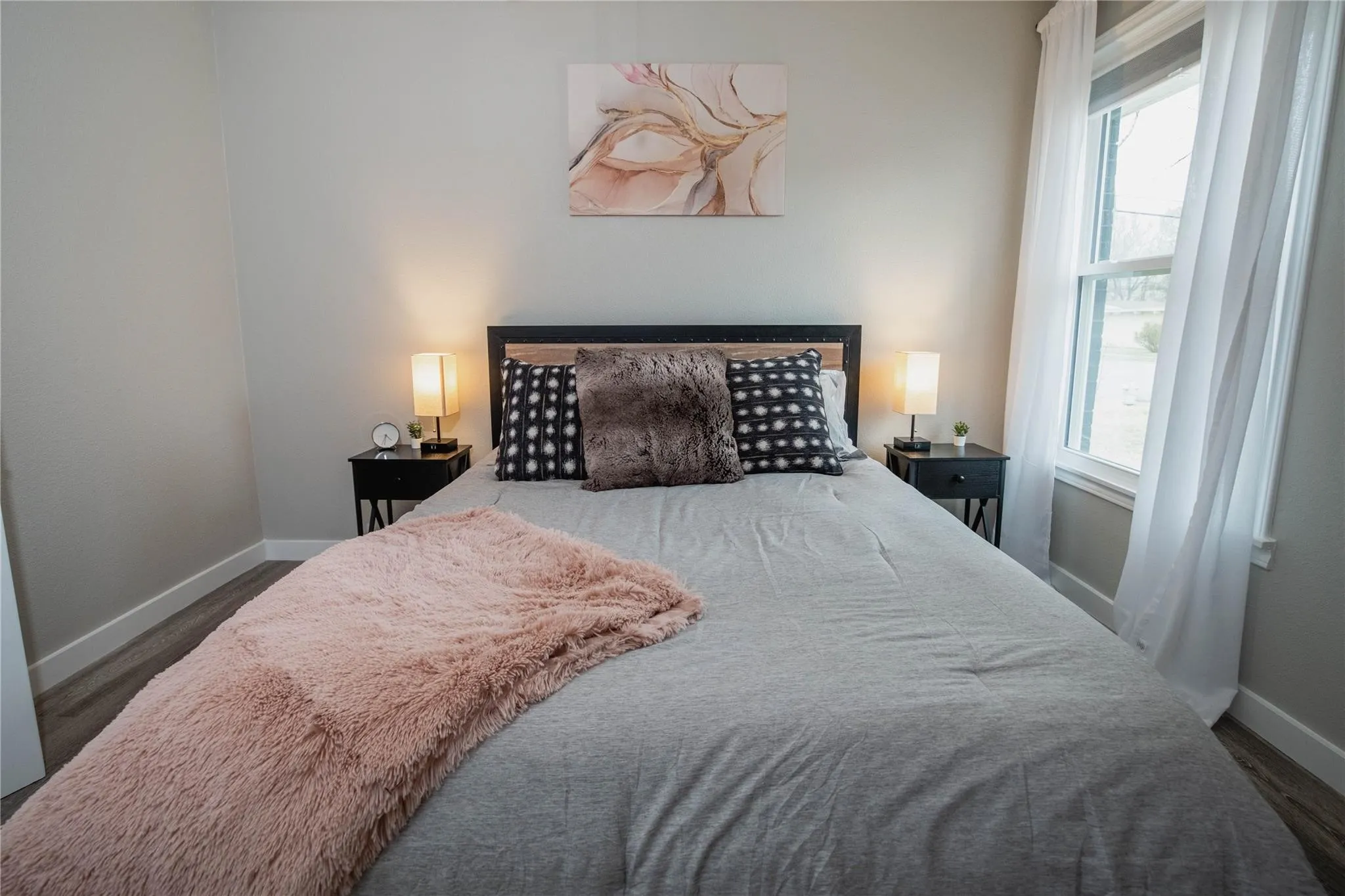 Bedroom featuring multiple windows and baseboards