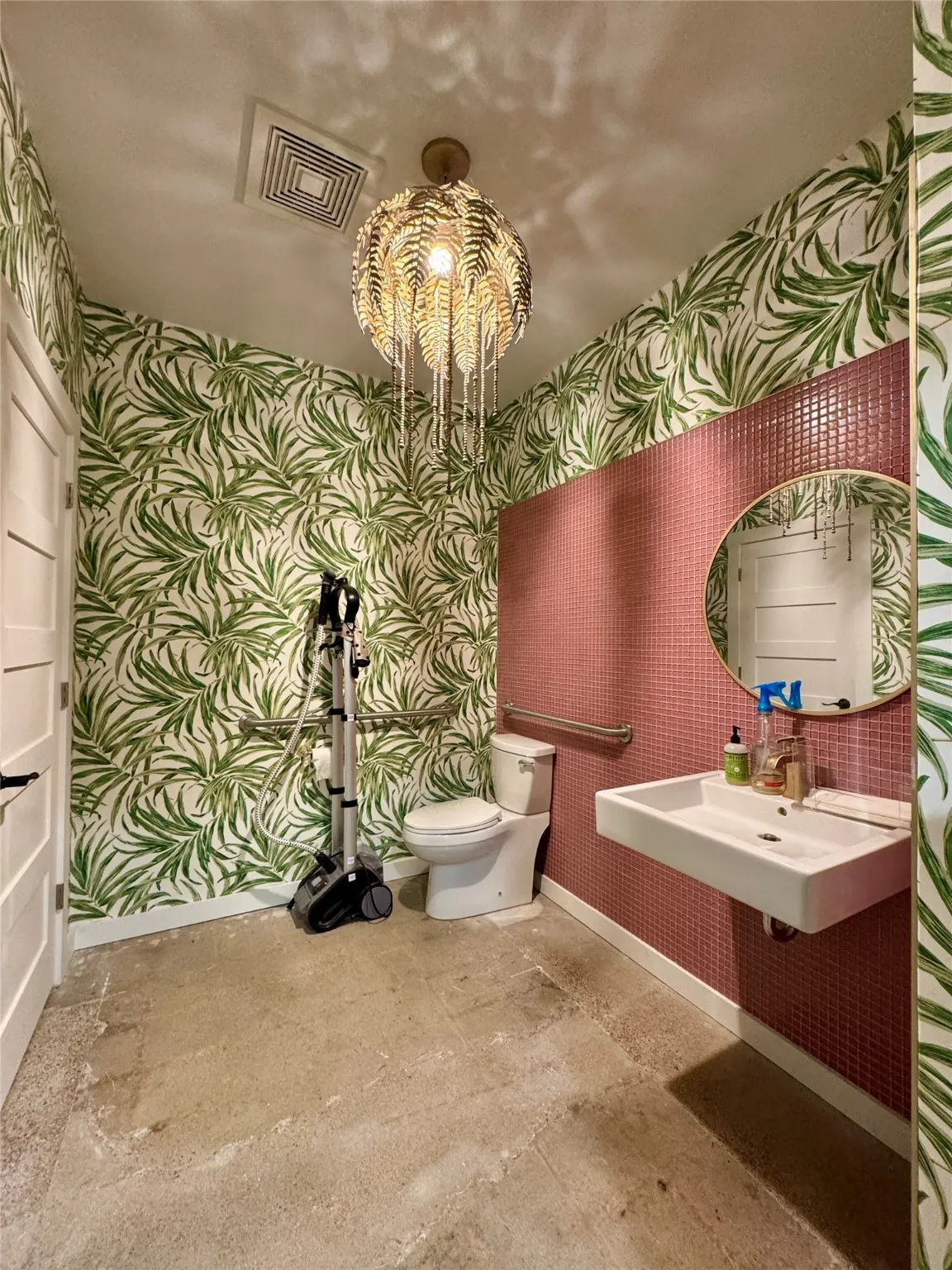 Half bath with wallpapered walls, baseboards, toilet, and a sink