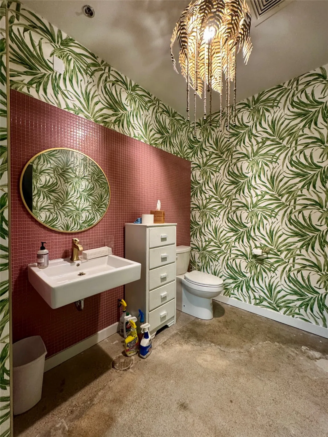 Half bath with wallpapered walls, baseboards, toilet, and a sink