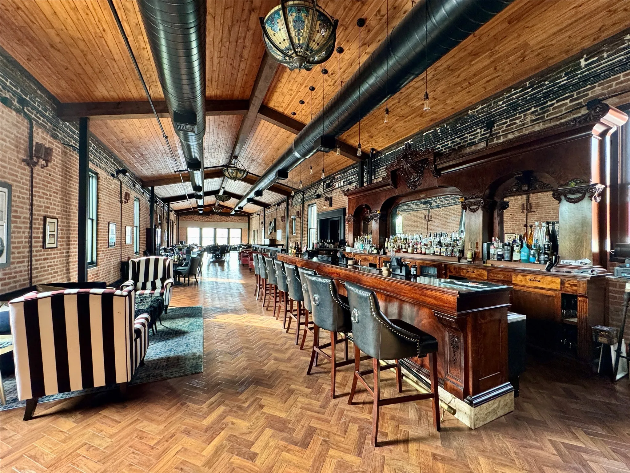 Community bar area with brick wall and vaulted ceiling