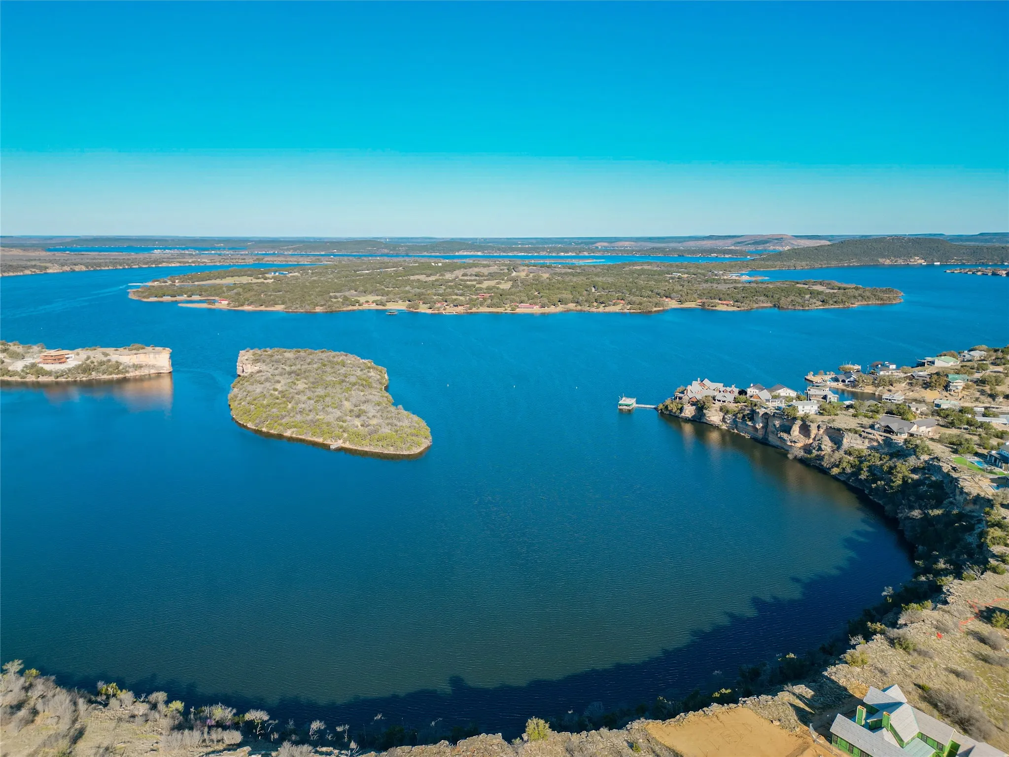Birds eye view of property with a water view