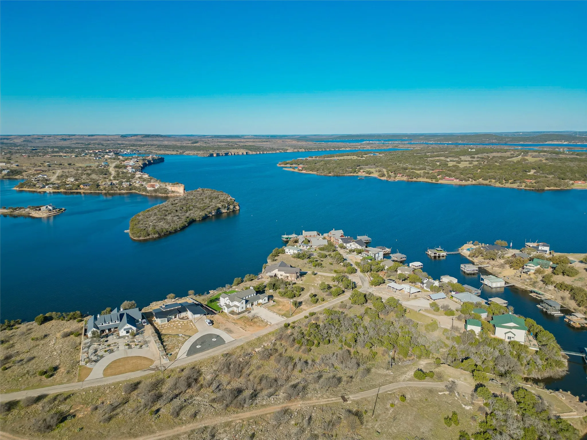Birds eye view of property with a water view