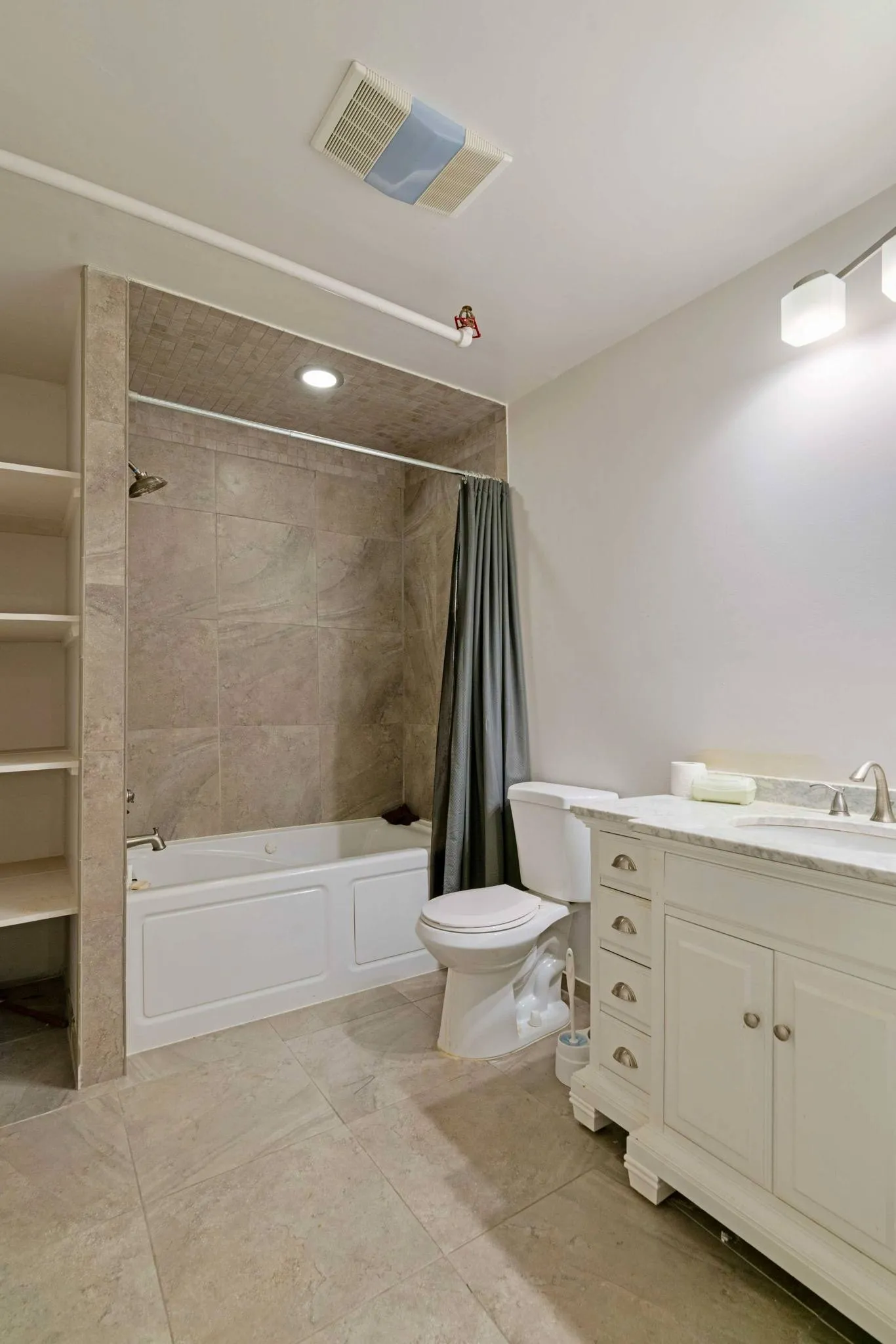 Bathroom with toilet, shower / bathtub combination with curtain, vanity, and tile patterned floors