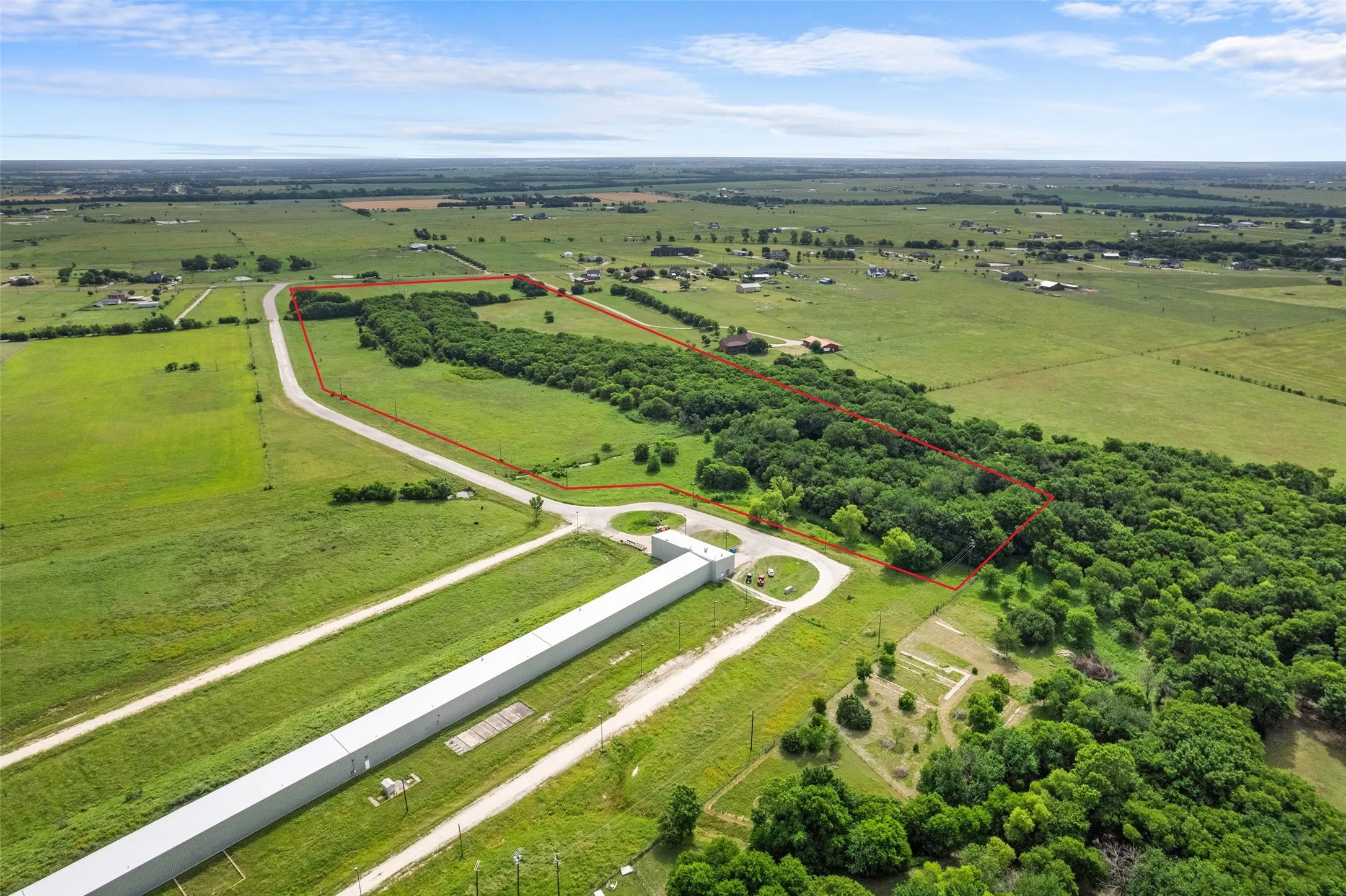 Aerial view of sparsely populated area with property boundaries highlighted