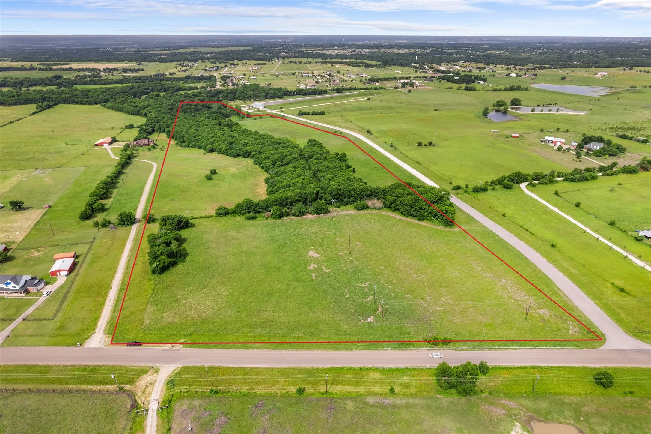 View of rural area featuring property boundaries highlighted and a nearby body of water