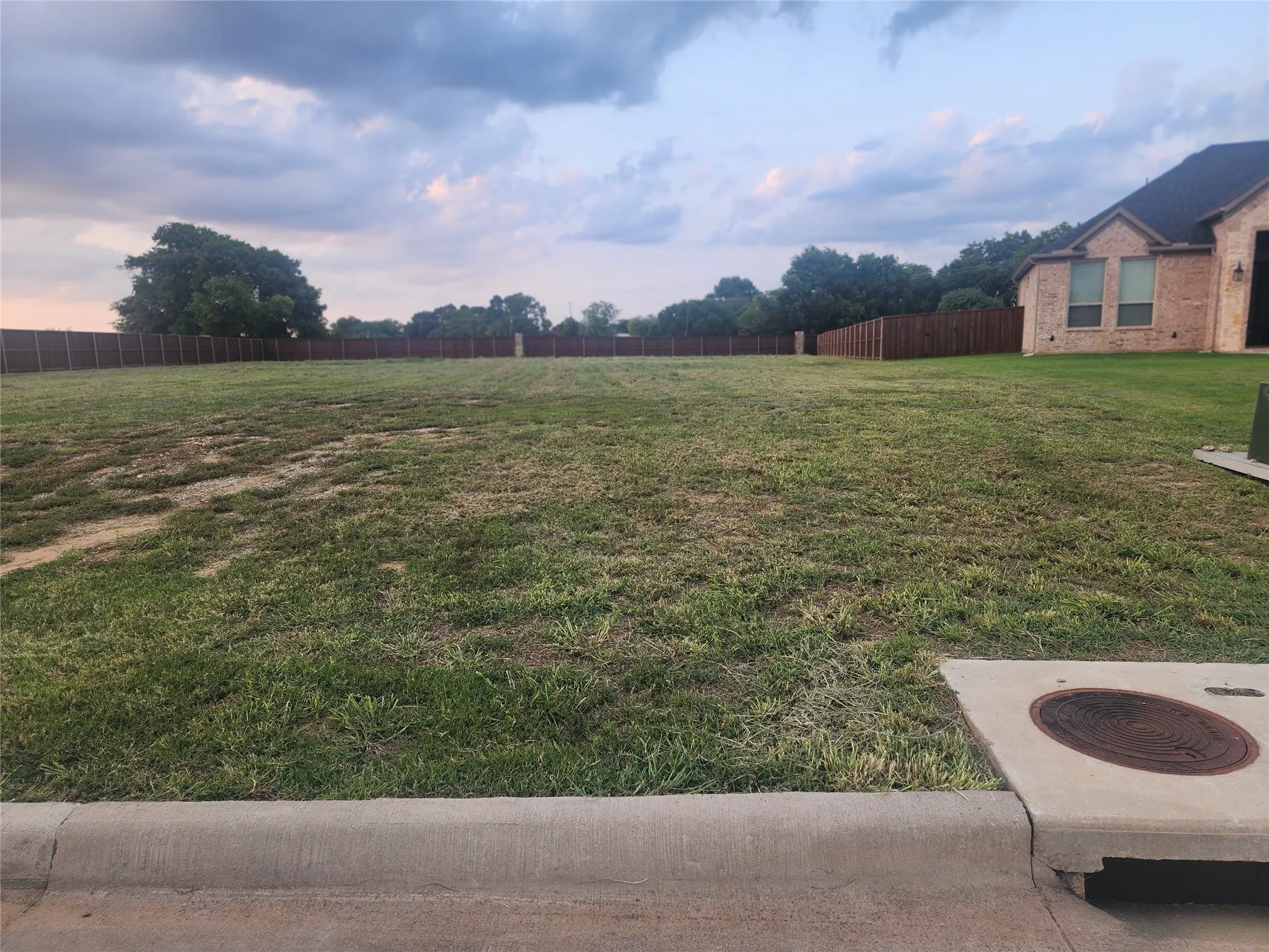 View of yard featuring fence