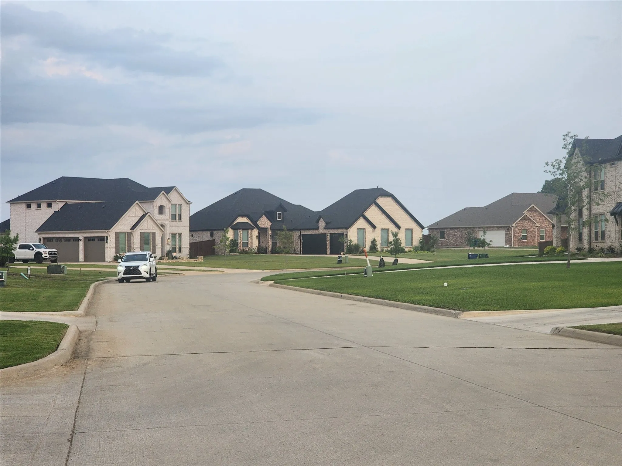 View of concrete street featuring curbs and a residential view