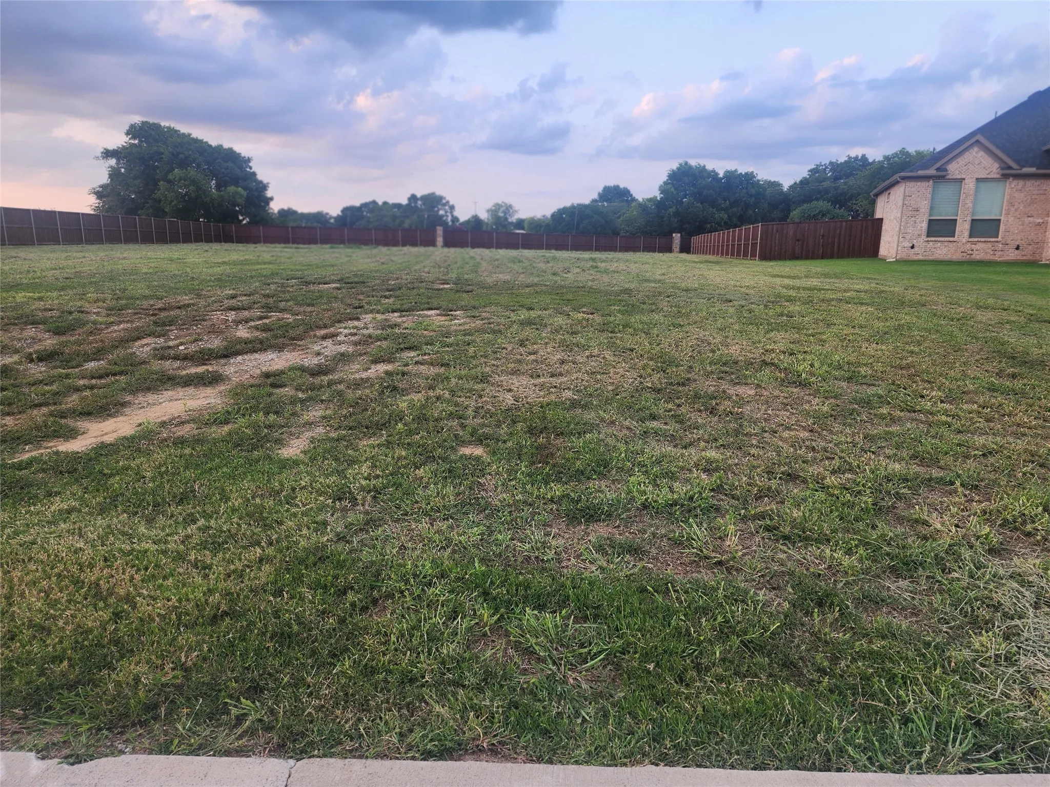 View of yard featuring fence