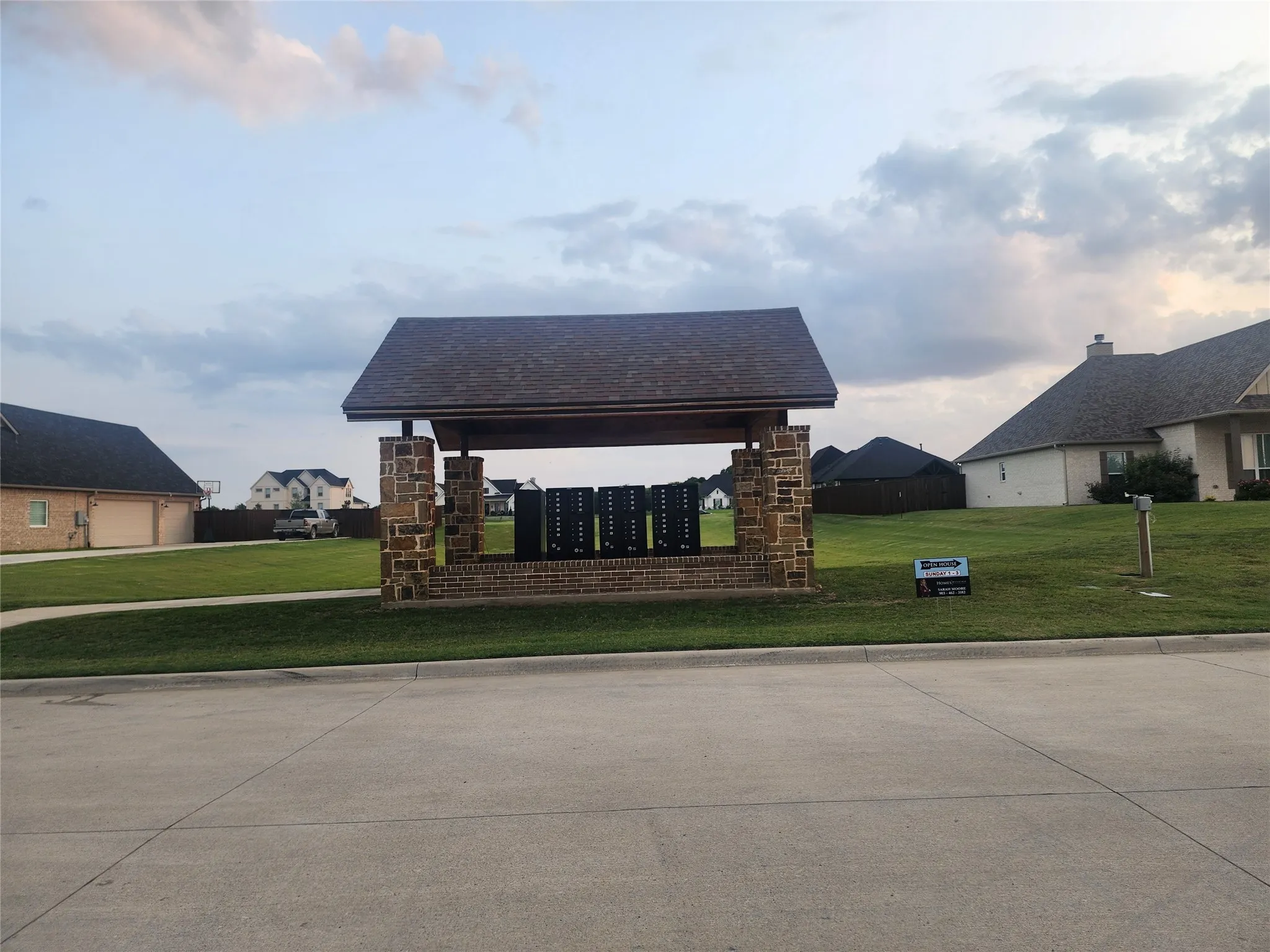 View of community with mail area and a yard