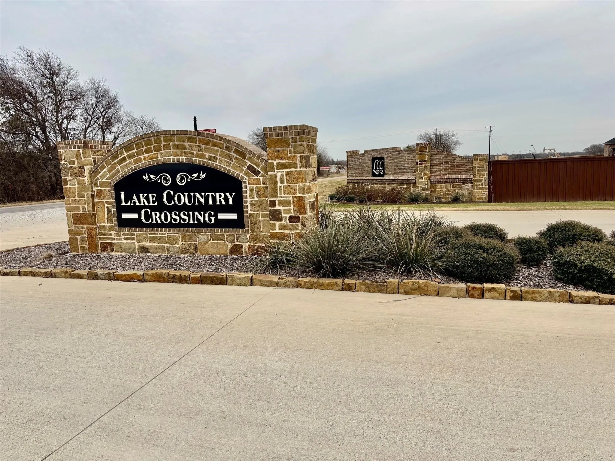 Community sign featuring fence