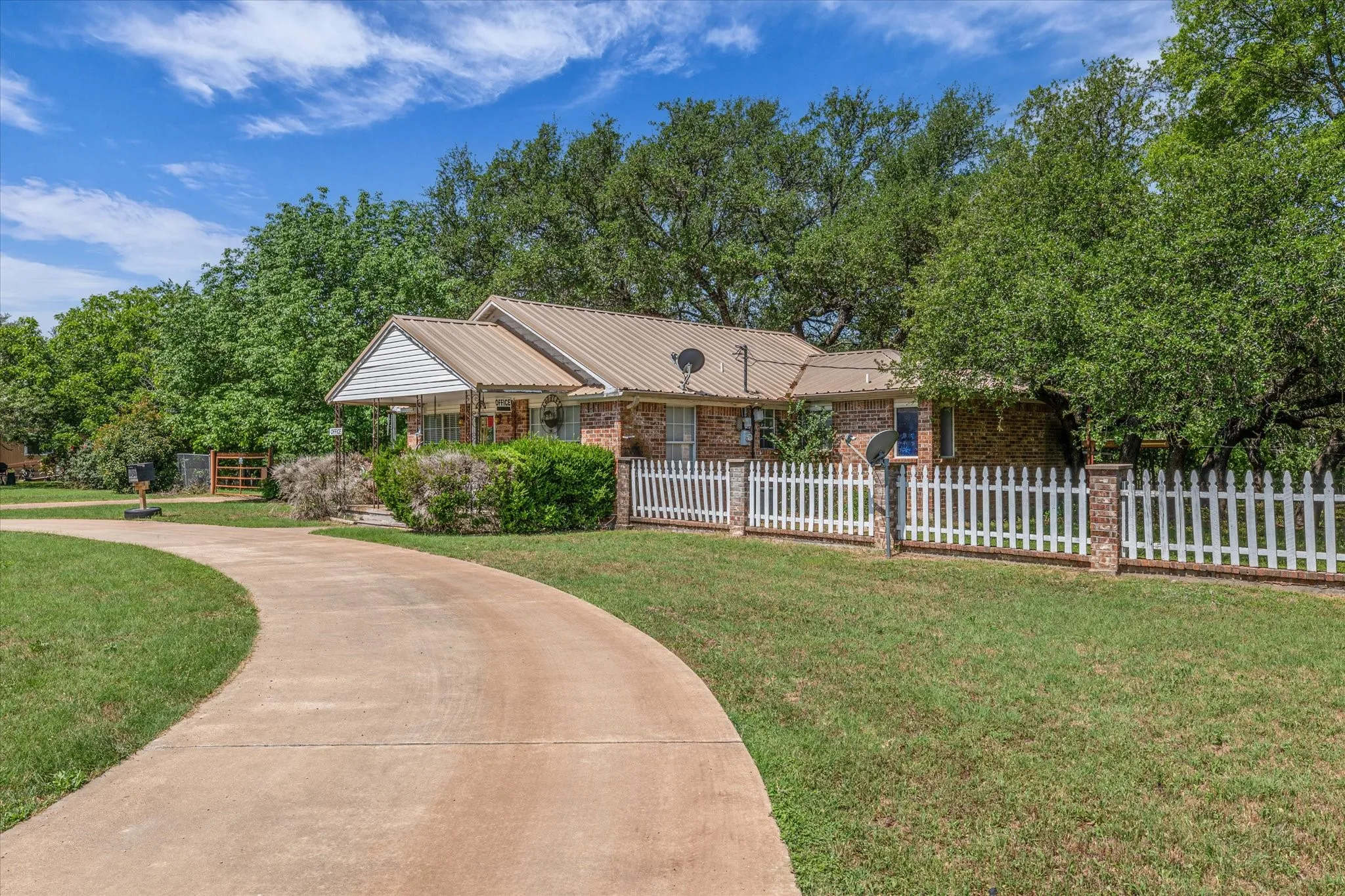 Ranch-style home with brick siding and metal roof