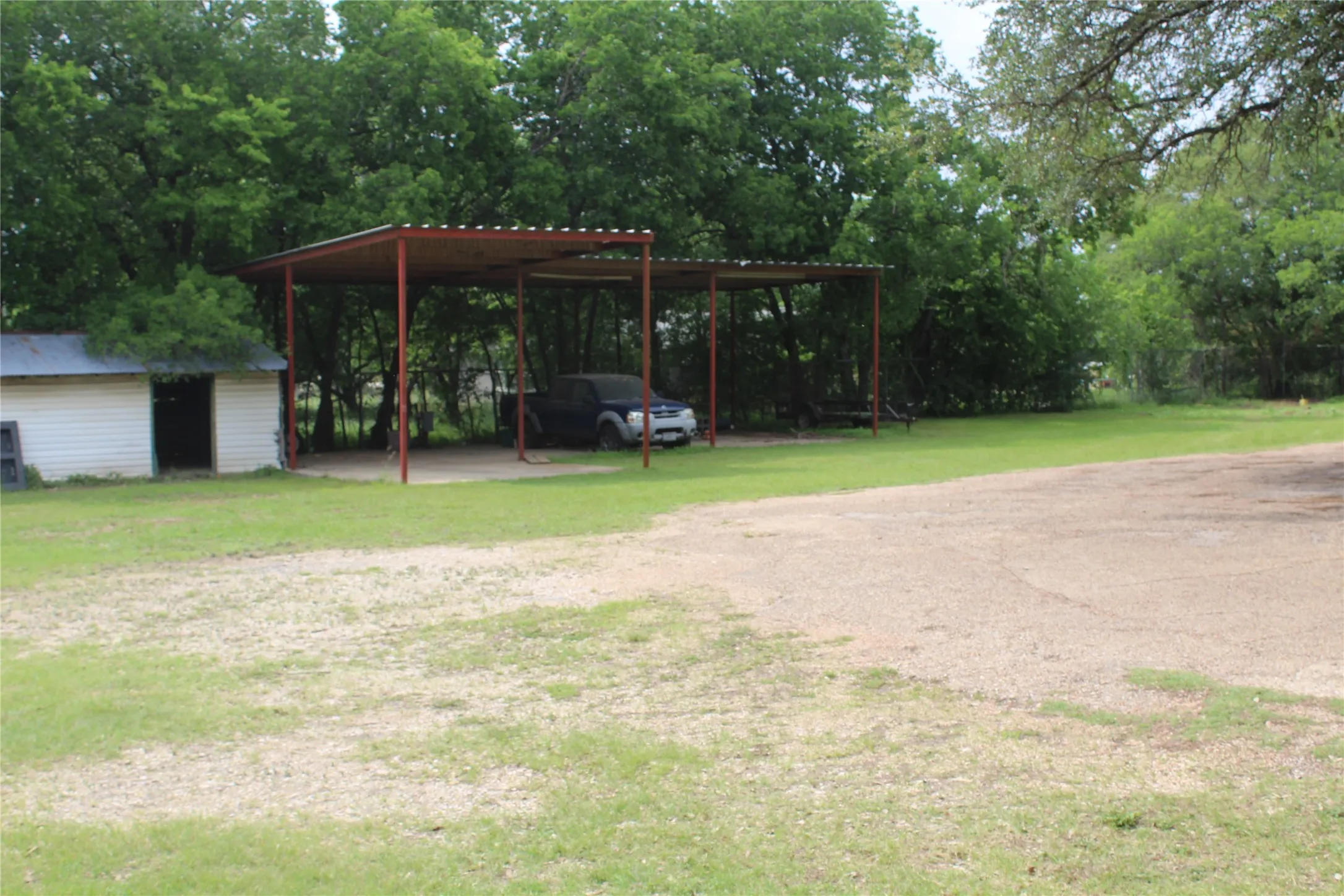 Carport structure with a metal roof and support pillars