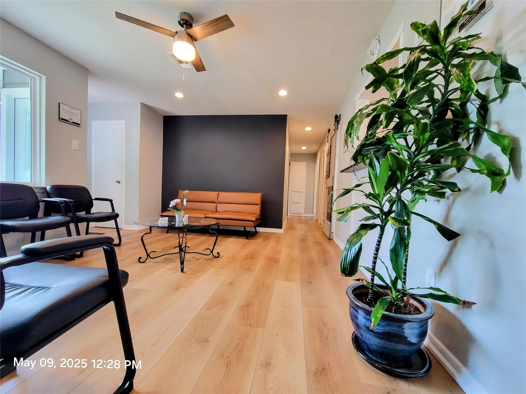 Living room with recessed lighting, light wood-type flooring, ceiling fan, and baseboards