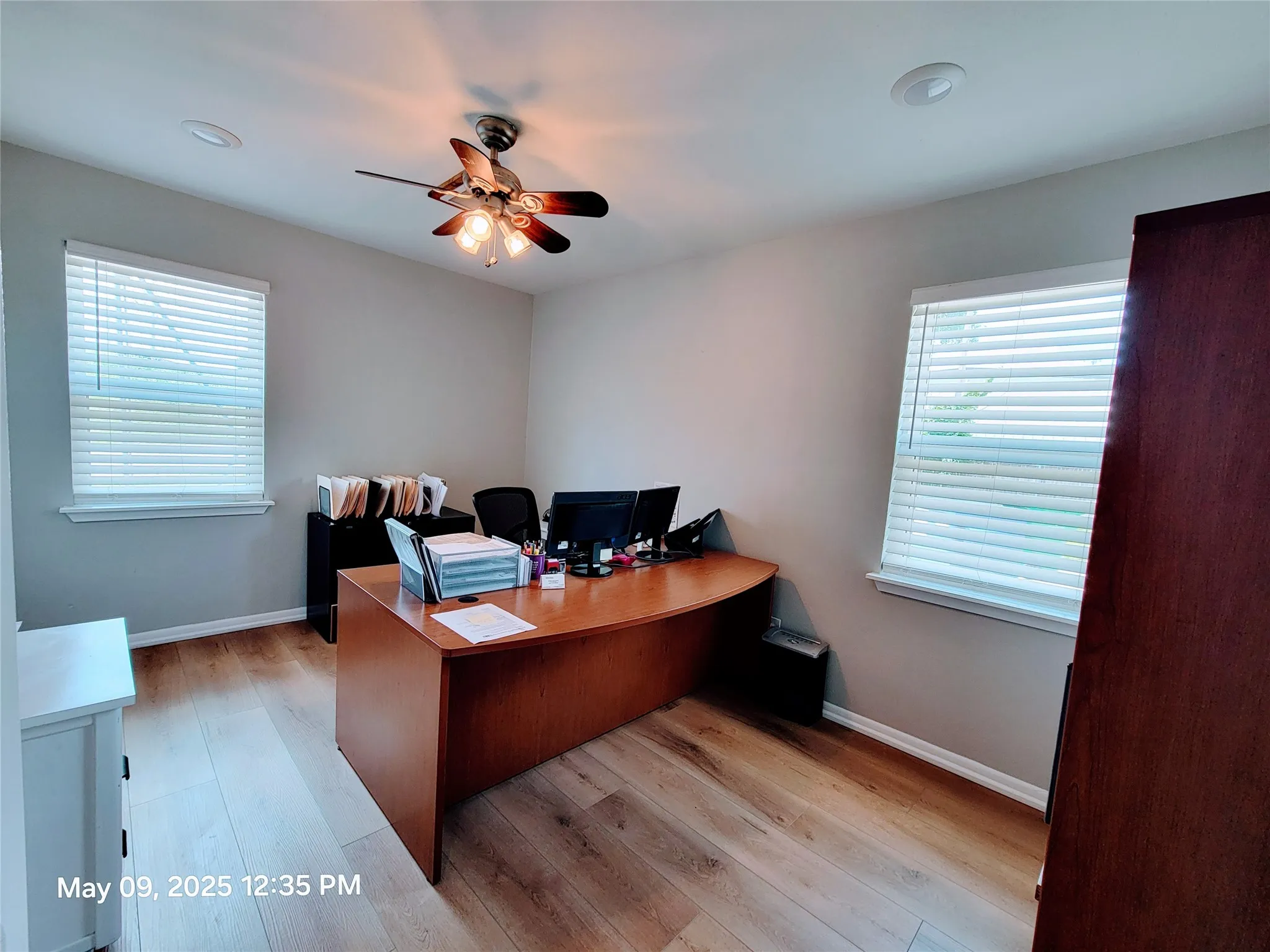Office featuring a ceiling fan, light wood-style flooring, and baseboards