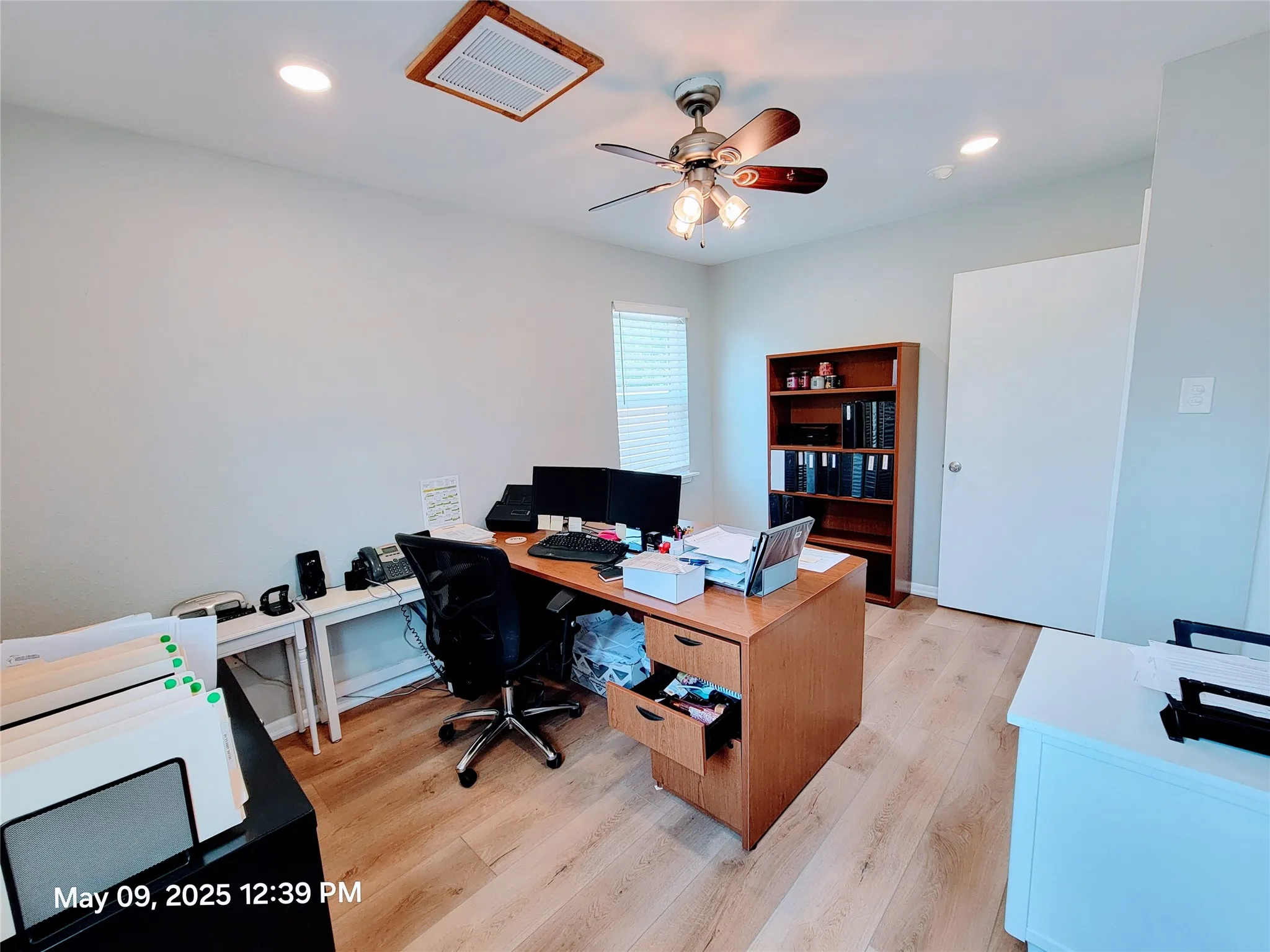 Office with light wood-type flooring, a ceiling fan, and recessed lighting