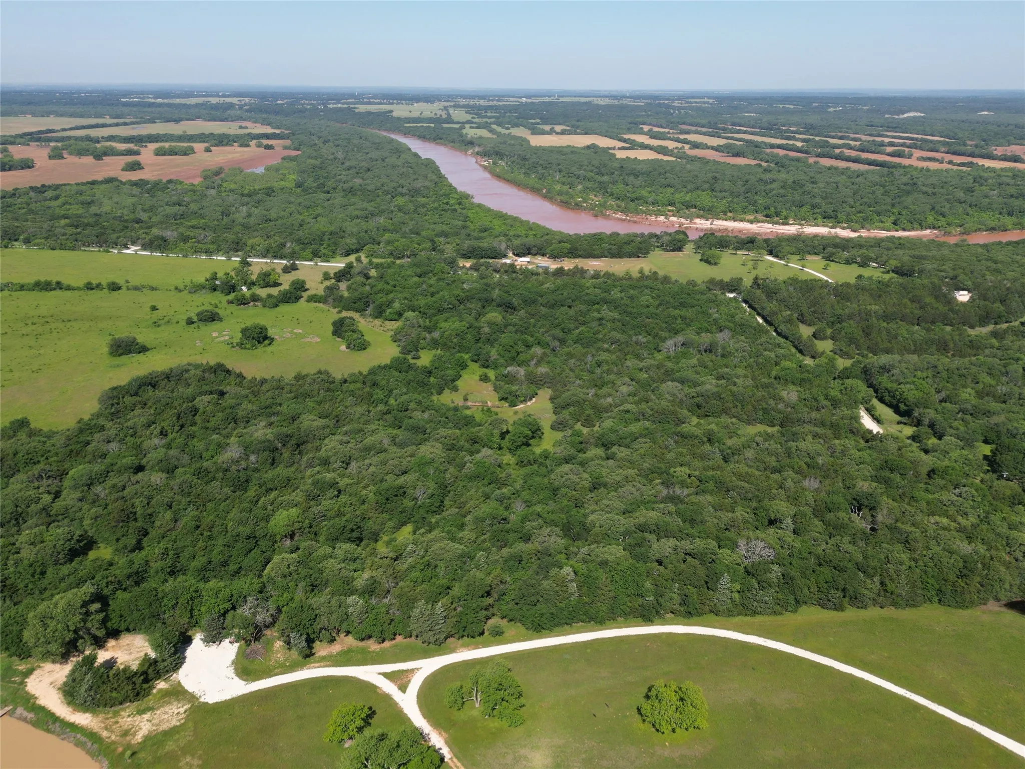 View from southeast side showing proximity to the Red River bordering northwest of property