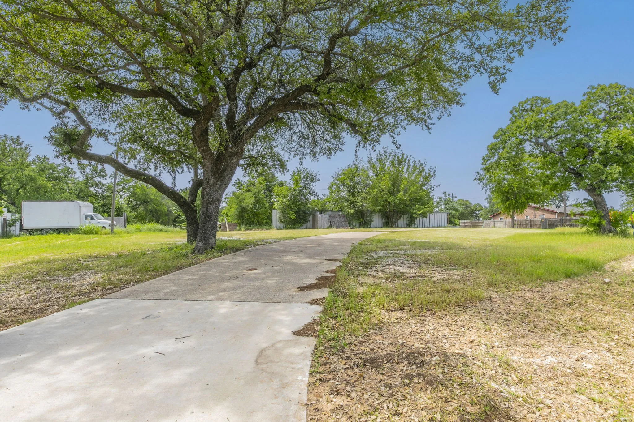 View of yard with fence and driveway