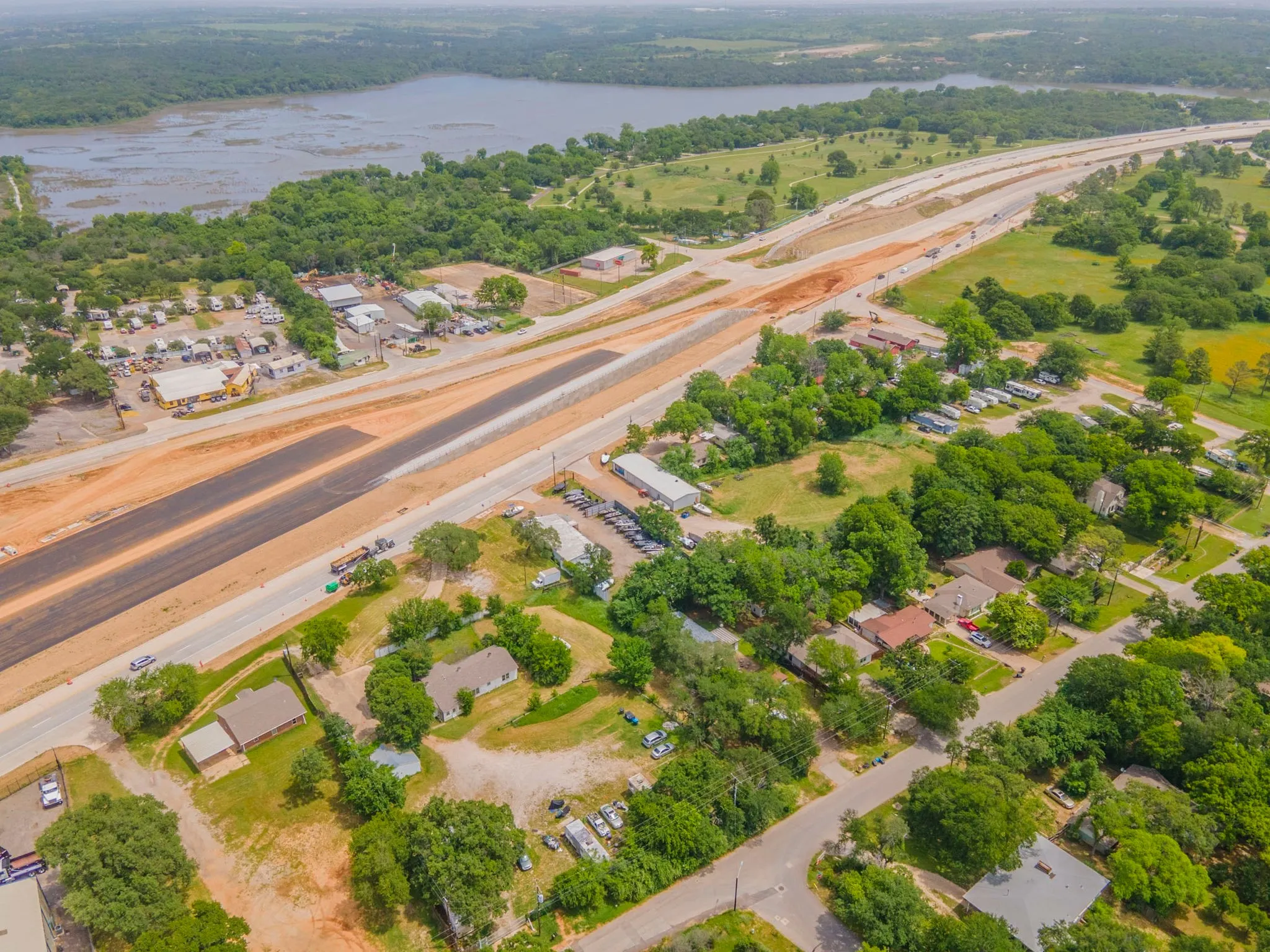 Aerial view of property and surrounding area featuring a large body of water