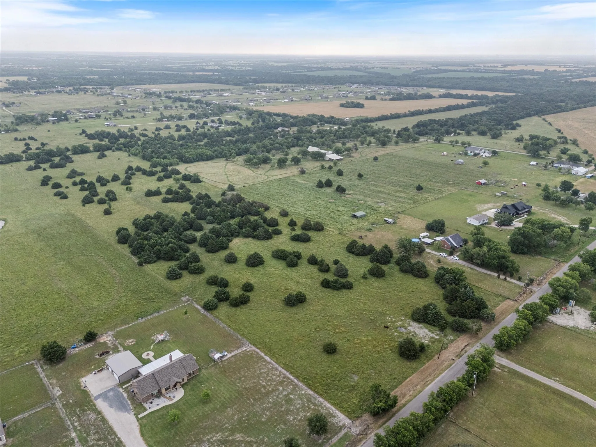 Aerial view of property and surrounding area featuring rural landscape