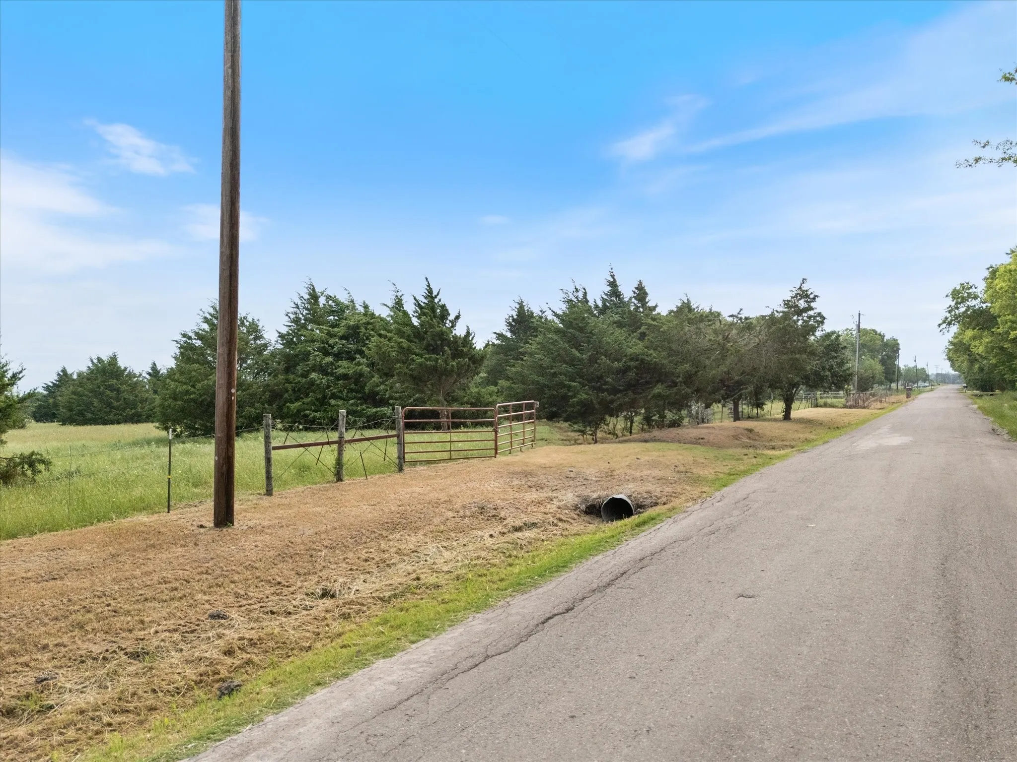 View of asphalt street featuring a rural view