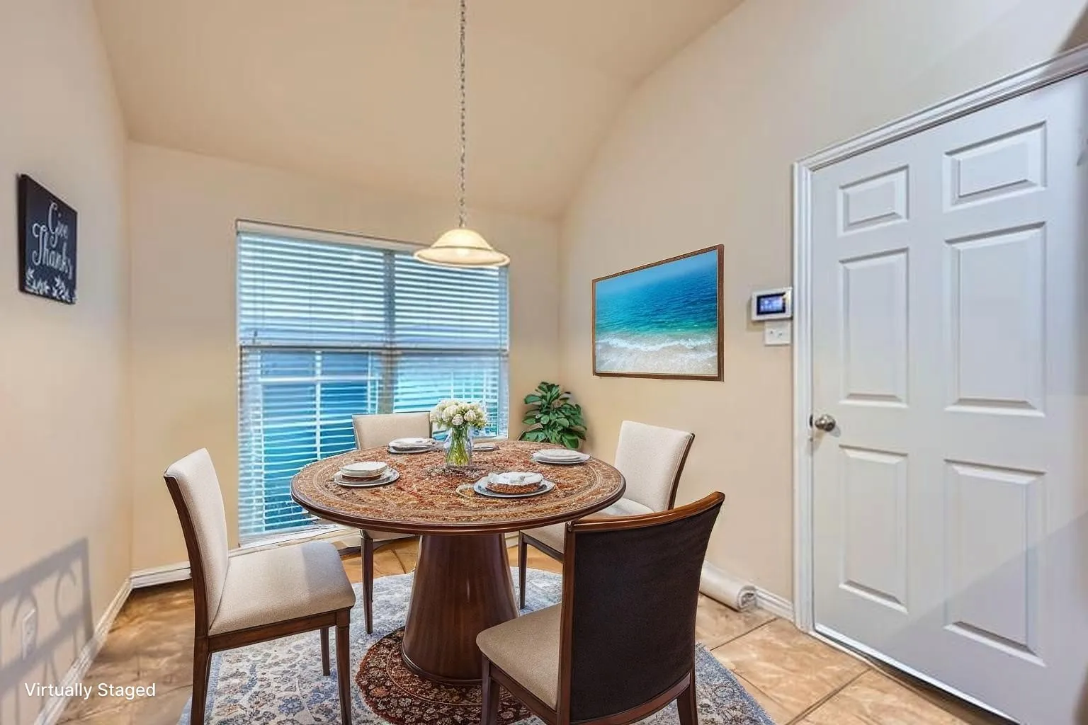 Dining space featuring vaulted ceiling, baseboards, and light tile patterned floors