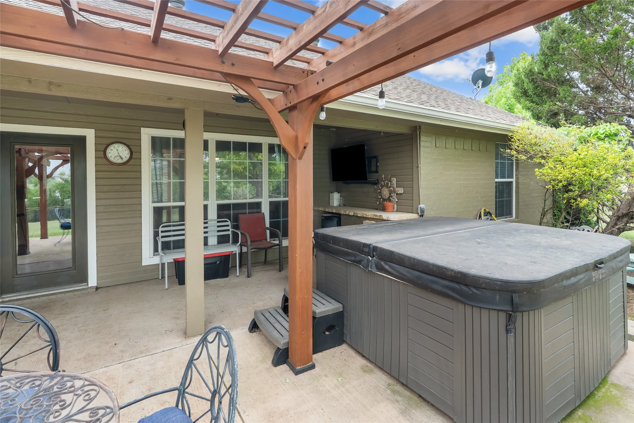 View of patio / terrace with a hot tub