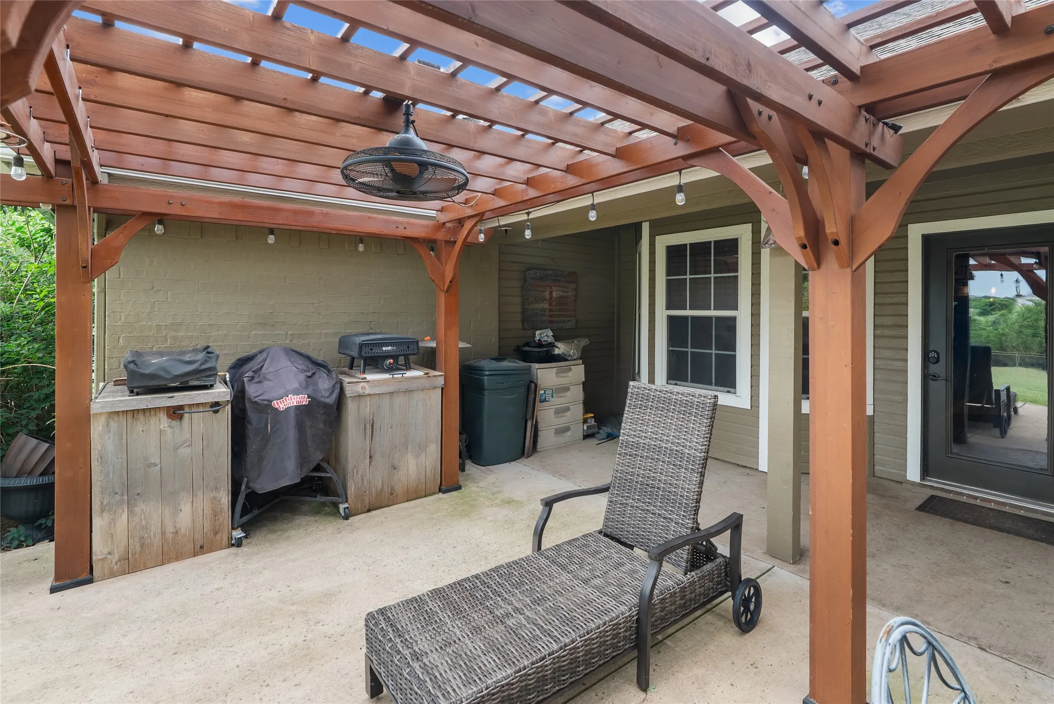 View of patio with a pergola and a grill