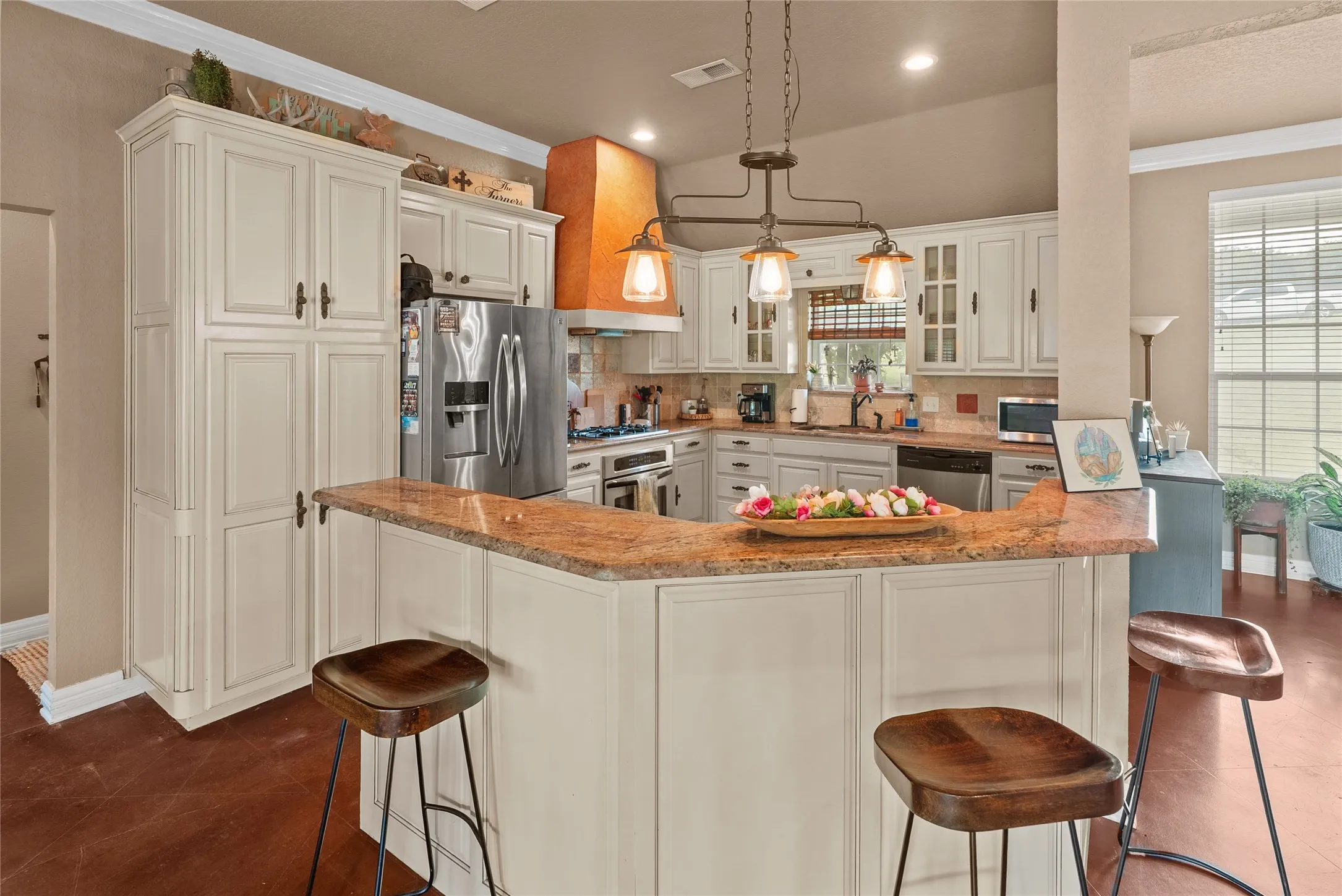 Kitchen with stainless steel appliances, glass insert cabinets, healthy amount of natural light, tasteful backsplash, and recessed lighting