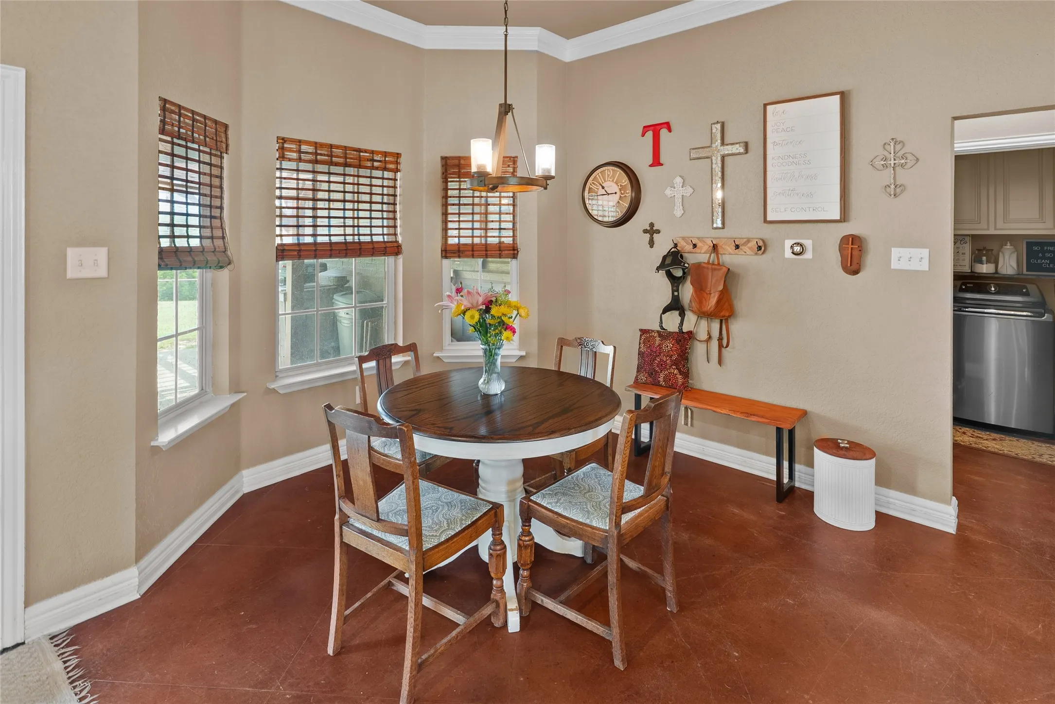 Dining area with ornamental molding, baseboards, and a chandelier