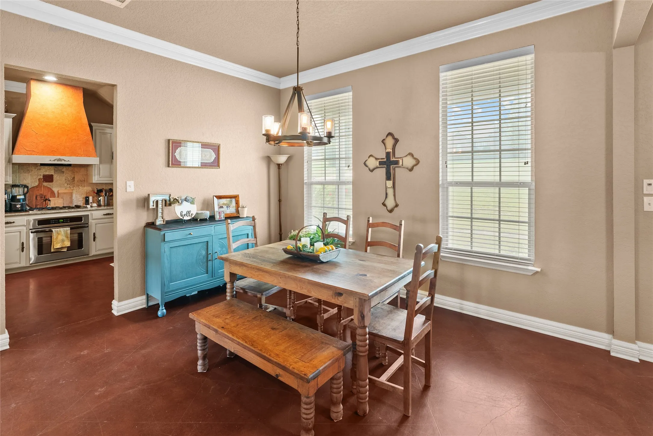 Dining space featuring ornamental molding, a chandelier, and baseboards