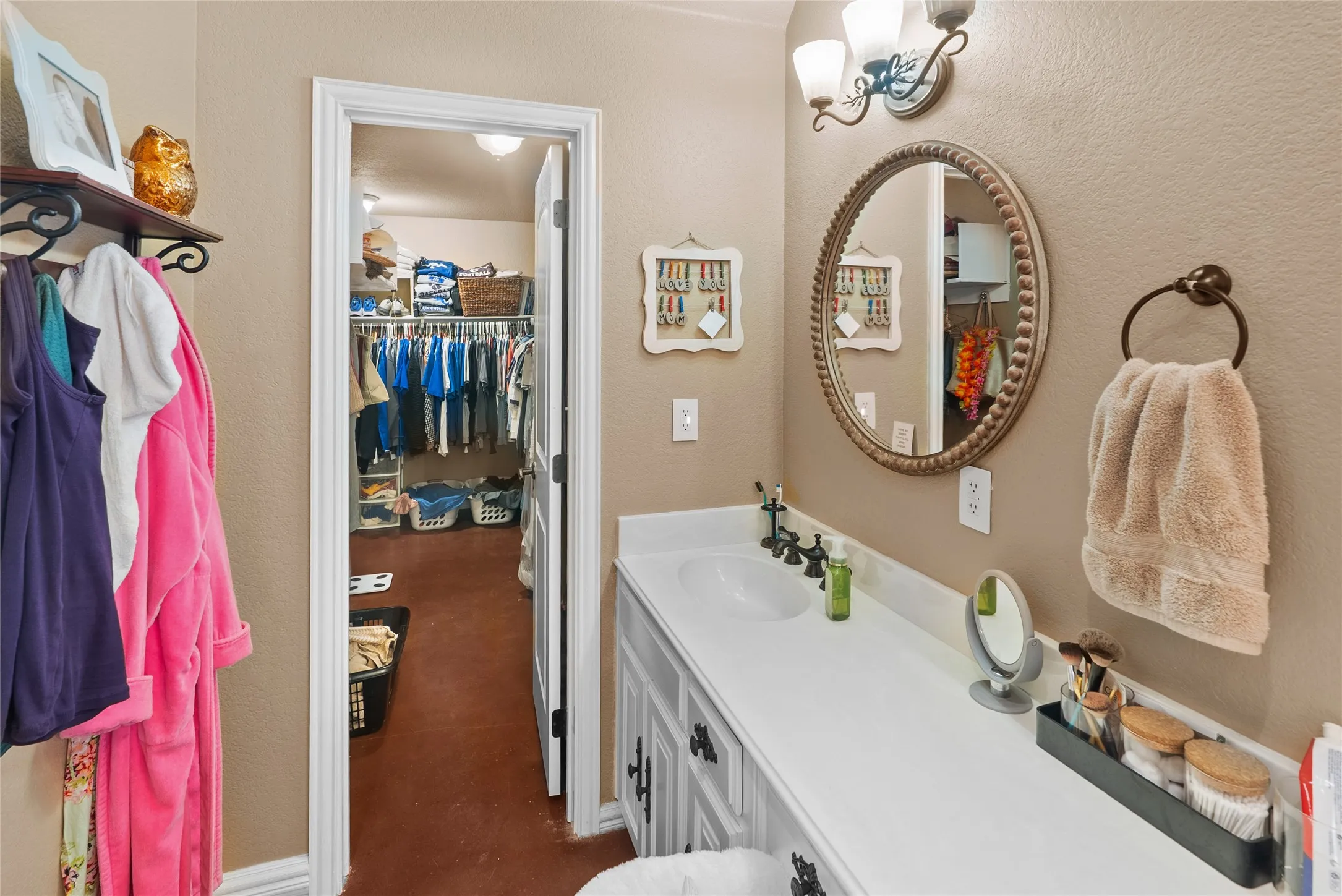 Bathroom featuring vanity and a spacious closet