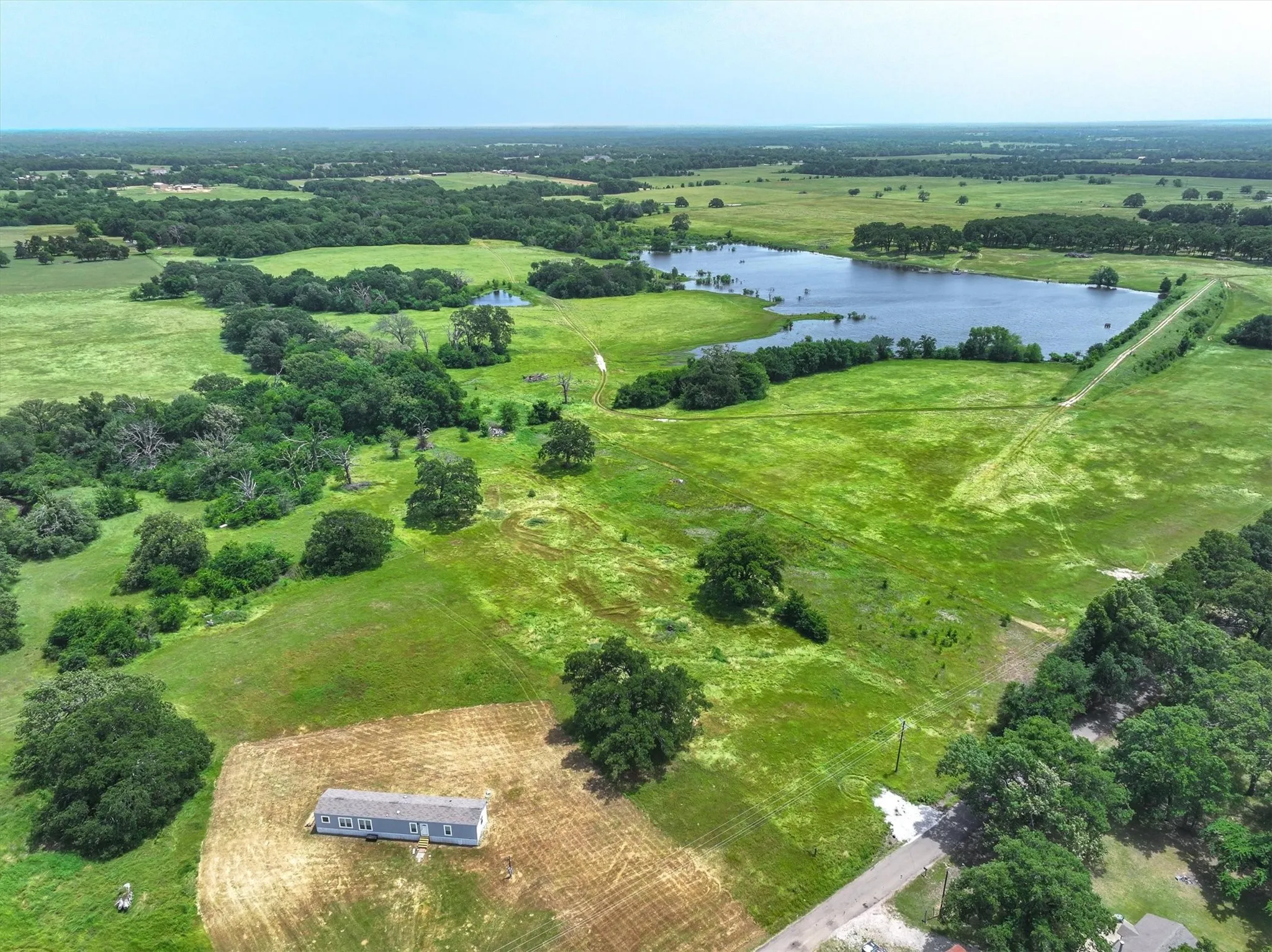 Overview of rural landscape with a nearby body of water