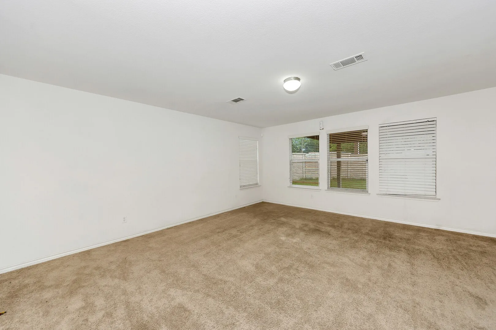 Unfurnished room featuring carpet floors and baseboards