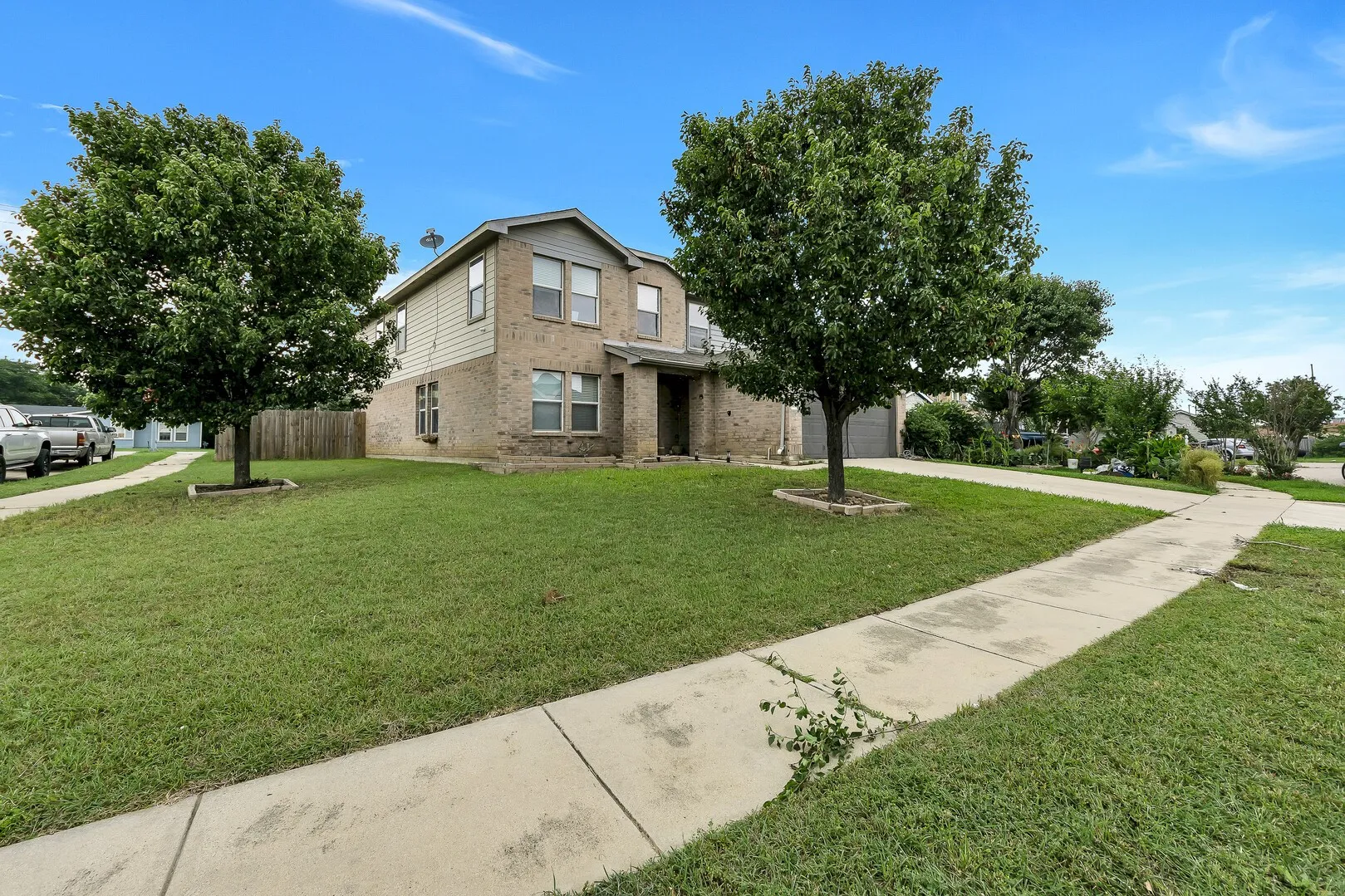 View of front of home featuring brick siding and driveway