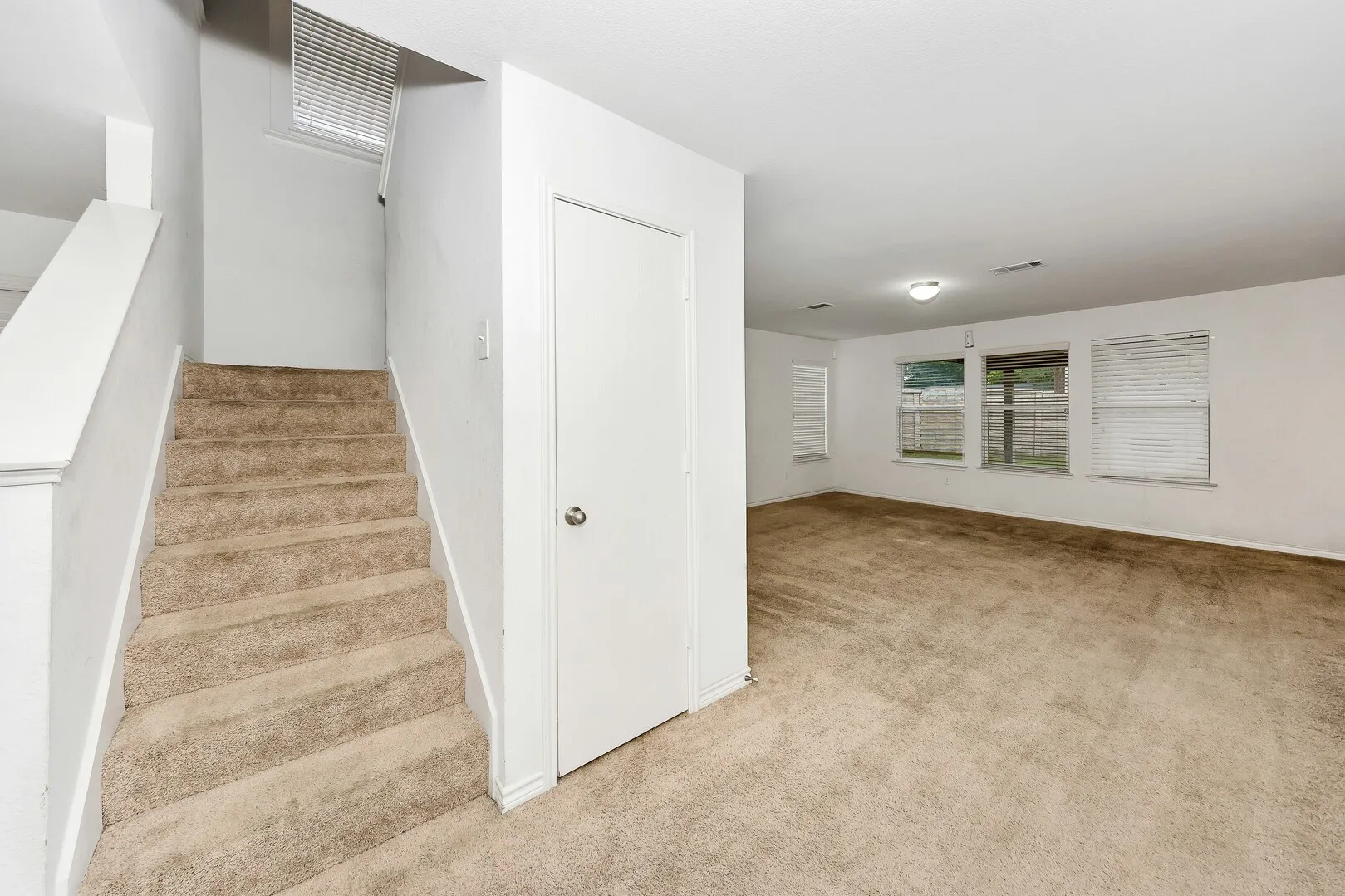 Stairs featuring carpet flooring and baseboards