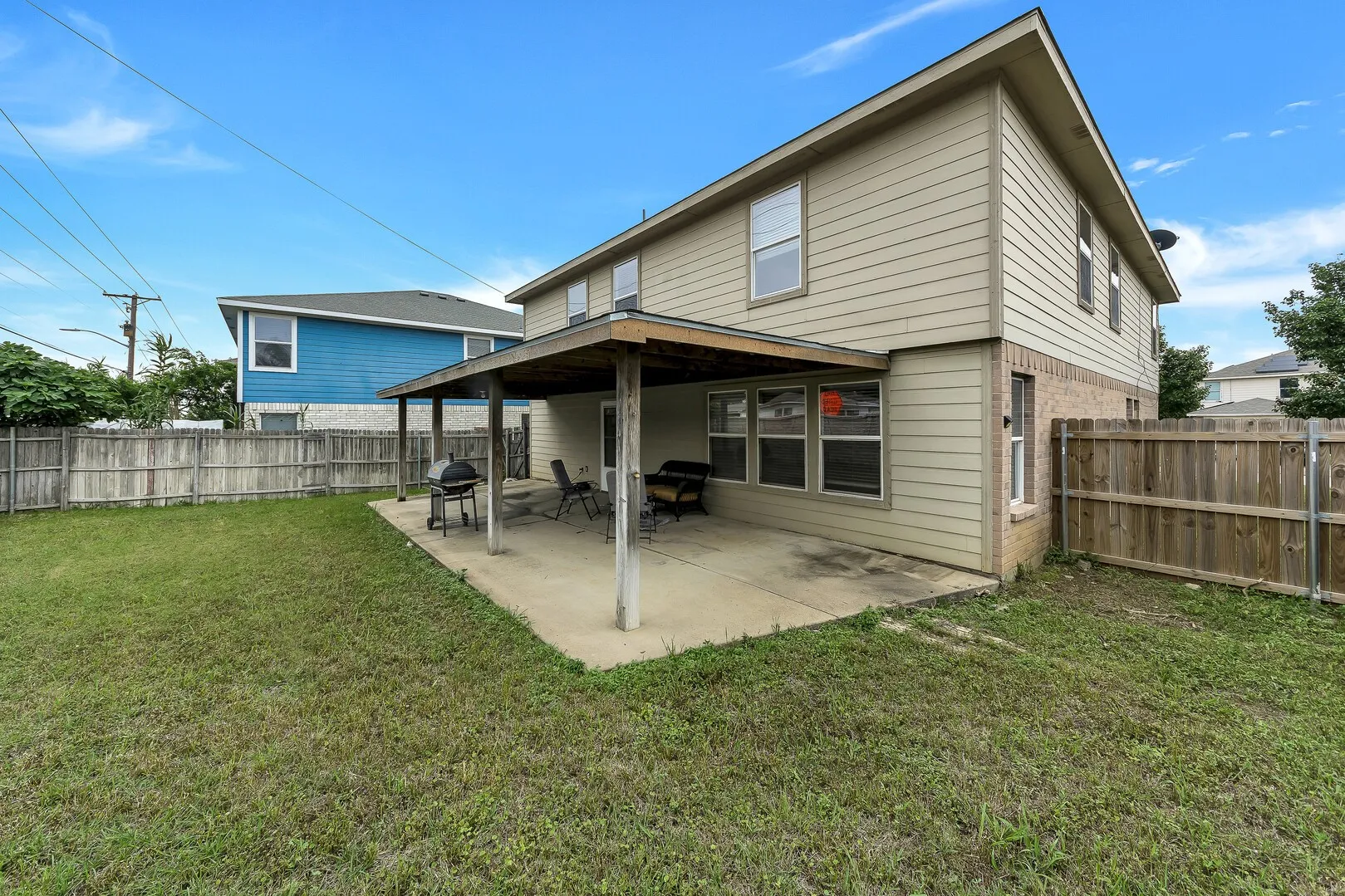 Back of house featuring brick siding and a patio