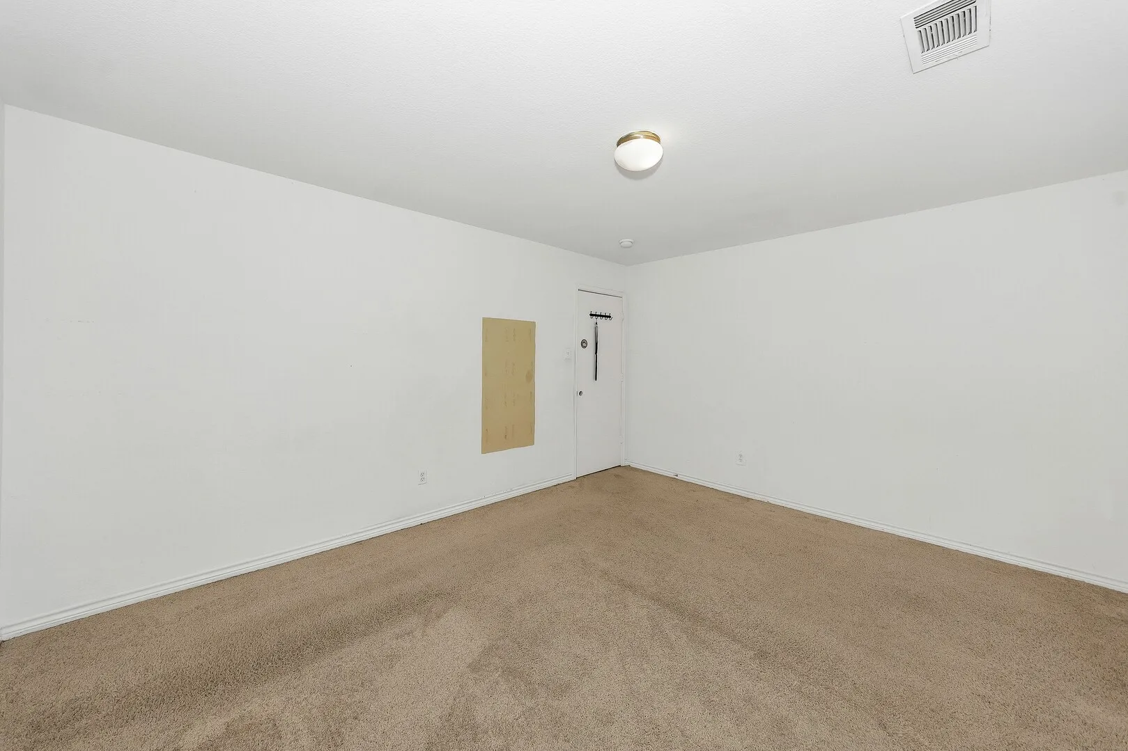 Unfurnished room featuring light colored carpet and baseboards