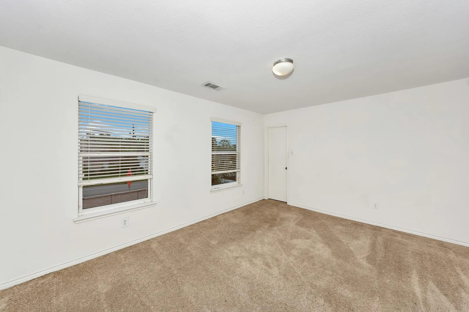 Carpeted empty room with baseboards