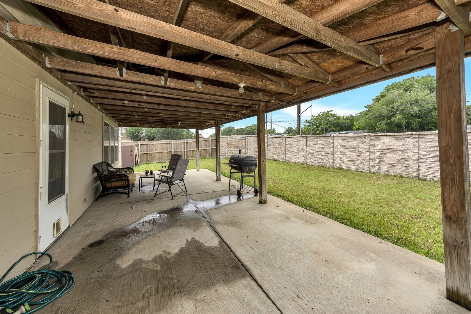 View of patio featuring a grill