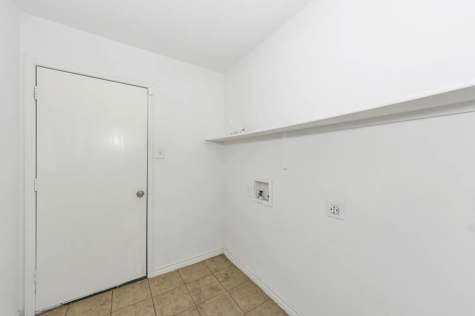 Washroom with washer hookup, baseboards, hookup for an electric dryer, and light tile patterned floors
