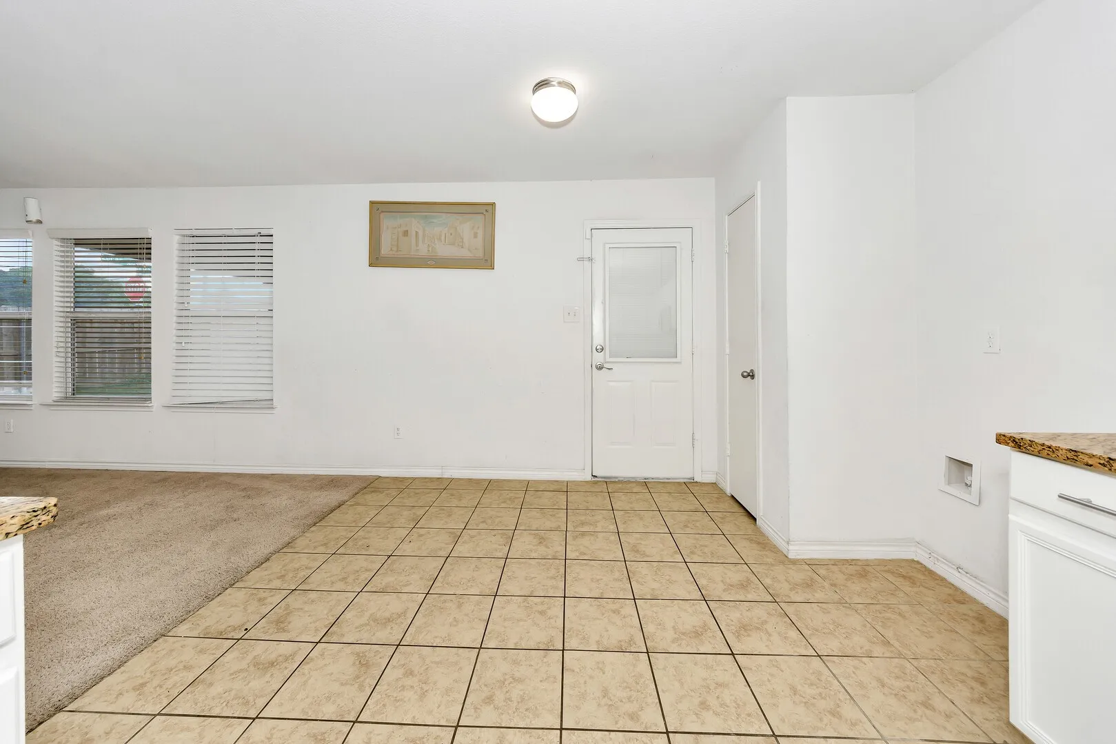 Unfurnished room featuring light tile patterned floors and baseboards